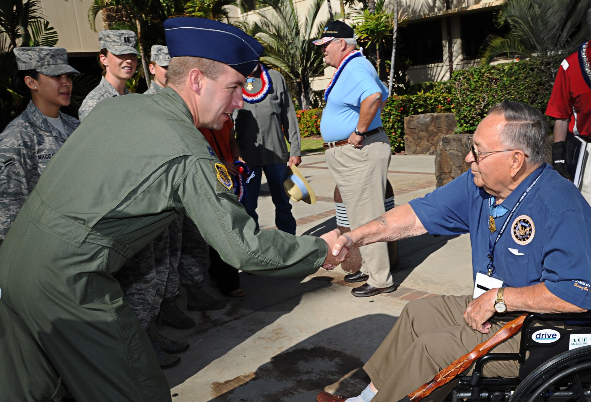 Capt. Andy Stewart, C-17 Globemaster III instructor pilot, greets Sgt. 1st Class (Ret.) Ronald Rosser, a U.S. Army veteran of the Korean War and a Medal of Honor recipient, while Rosser, along with three other Medal of Honor recipients, visited Joint Base Pearl Harbor-Hickam, Hawaii, Oct. 4. Rosser was a corporal when he performed the actions that earned him his medal on the side of a snow-covered hill in 1952. (U.S. Air Force photo/Senior Airman Lauren Main)