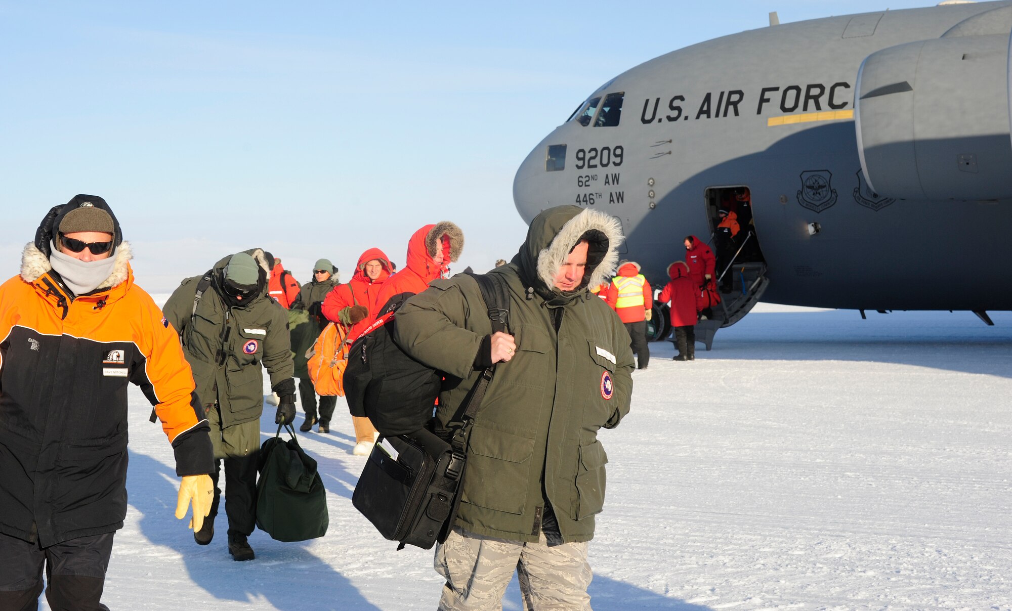 National Science Foundation personnel exit a C-17 Globemaster III aircraft, Oct. 1, 2012, at McMurdo Station, Antarctica. Every year, Airmen from the 62nd and 446th Airlift Wings at Joint Base Lewis-McChord, Wash., deploy to transport cargo and personnel in support of the NSF and Operation Deep Freeze. (U.S. Air Force photo/Staff Sgt. Sean Tobin)