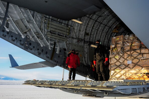 Loadmasters from the 62nd and 446th Airlift Wings, Joint Base Lewis-McChord, Wash., wearing extreme cold weather gear, await a forklift, Oct. 1, 2012, at McMurdo Station, Antarctica. The weather at the research center reached minus 35 degrees Fahrenheit. (U.S. Air Force photo/Staff Sgt. Sean Tobin)