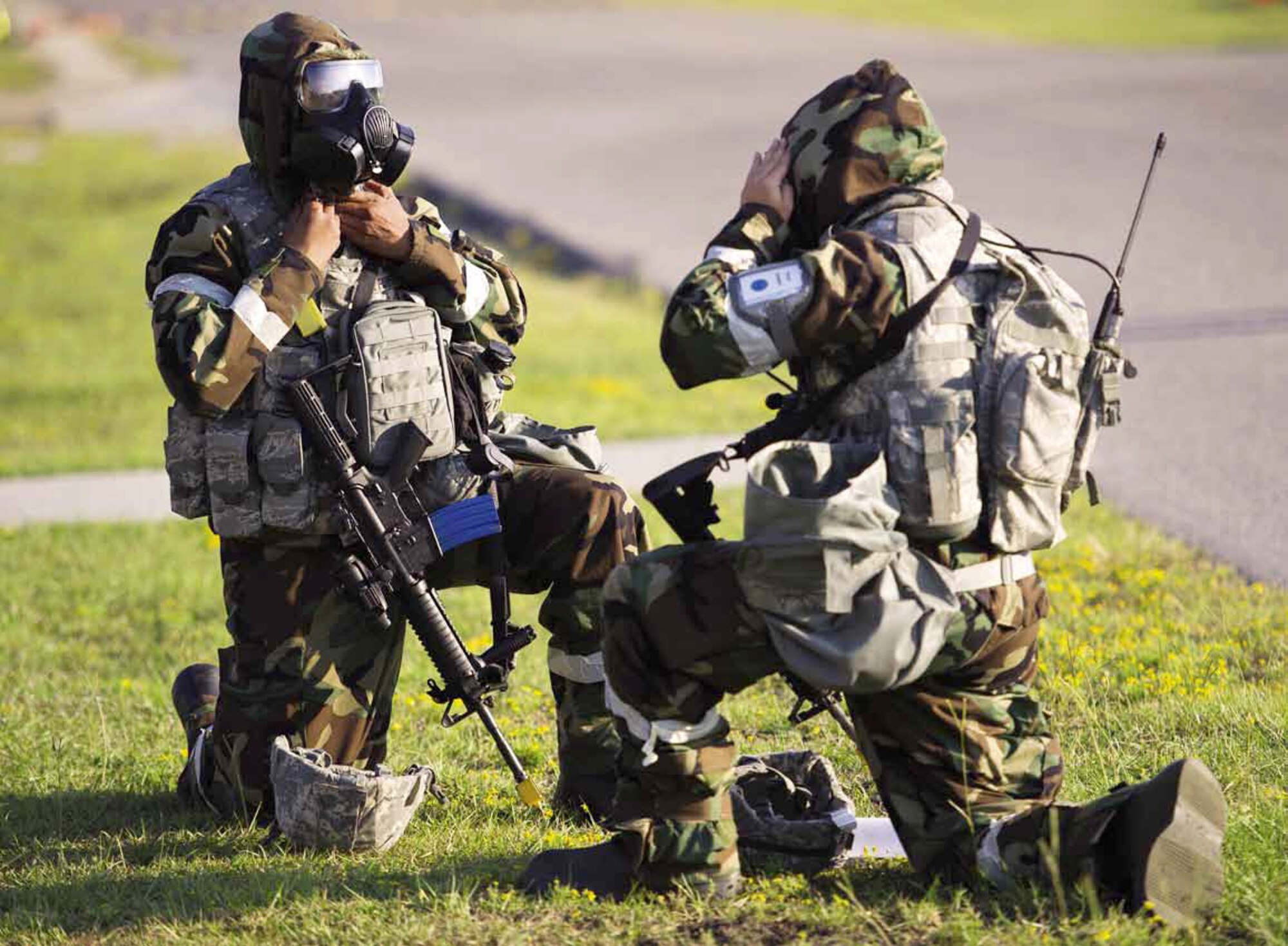 U.S. Airmen from March Air Reserve Base, Calif., prepare for MOPP 4 conditions during the Operational Readiness Exercise, Crisis Challenge 09-12B, at the Combat Readiness Center in Gulfport, Miss., Sept. 17, 2012. As shown, members are required to don their protective masks in the one-knee down position.  (U.S. Air Force photo by Tech. Sgt. Efren Lopez)
