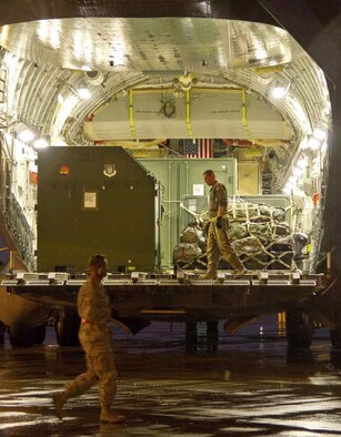 U.S. Airmen from March Air Reserve base, Calif., prepare to unload a C-17 Globemaster III aircraft, transporting service members and equipment to take part in
Operational Readiness Exercise, Crisis Challenge 09-12B, at the Combat Readiness
Center in Gulfport, Miss., Sept. 17, 2012. During the exercise, evaluators determine wing members’ ability to mobilize, deploy, survive in combat environments and redeploy to home station. (U.S. Air Force photo by Tech. Sgt. Efren Lopez)

