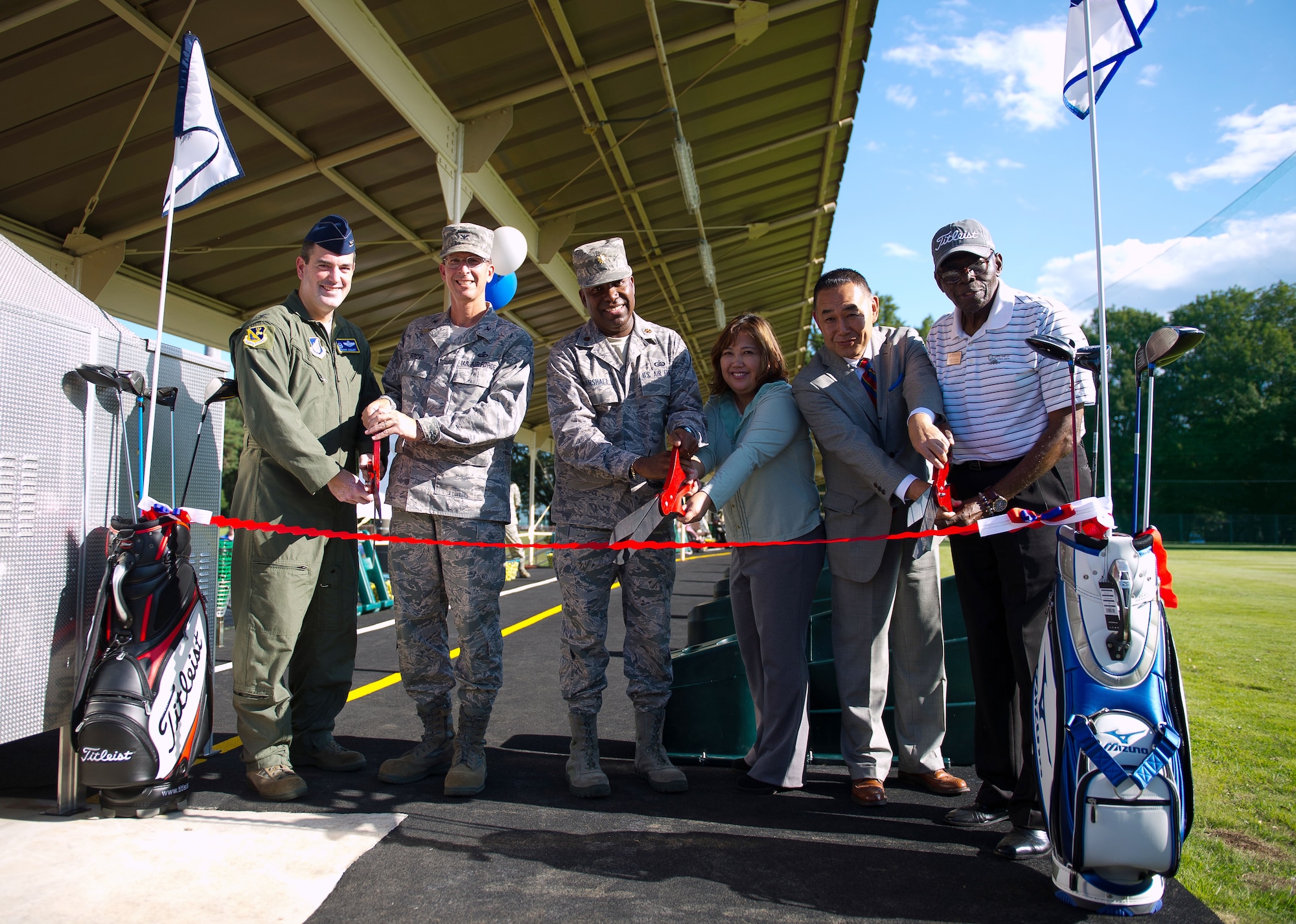 YOKOTA AIR BASE, Japan – Yokota leadership  poses for a photo before cutting the ceremonial ribbon symbolizing the grand opening of the Yokota driving range, Yokota Air Base, Japan, on Oct. 4, 2012. With new mats, ball dispenser and added length, Yokota patrons can enjoy a new addition to the morale, welfare and recreation facilities. (U.S. Air Force photo by Staff Sgt. Chad C. Strohmeyer)