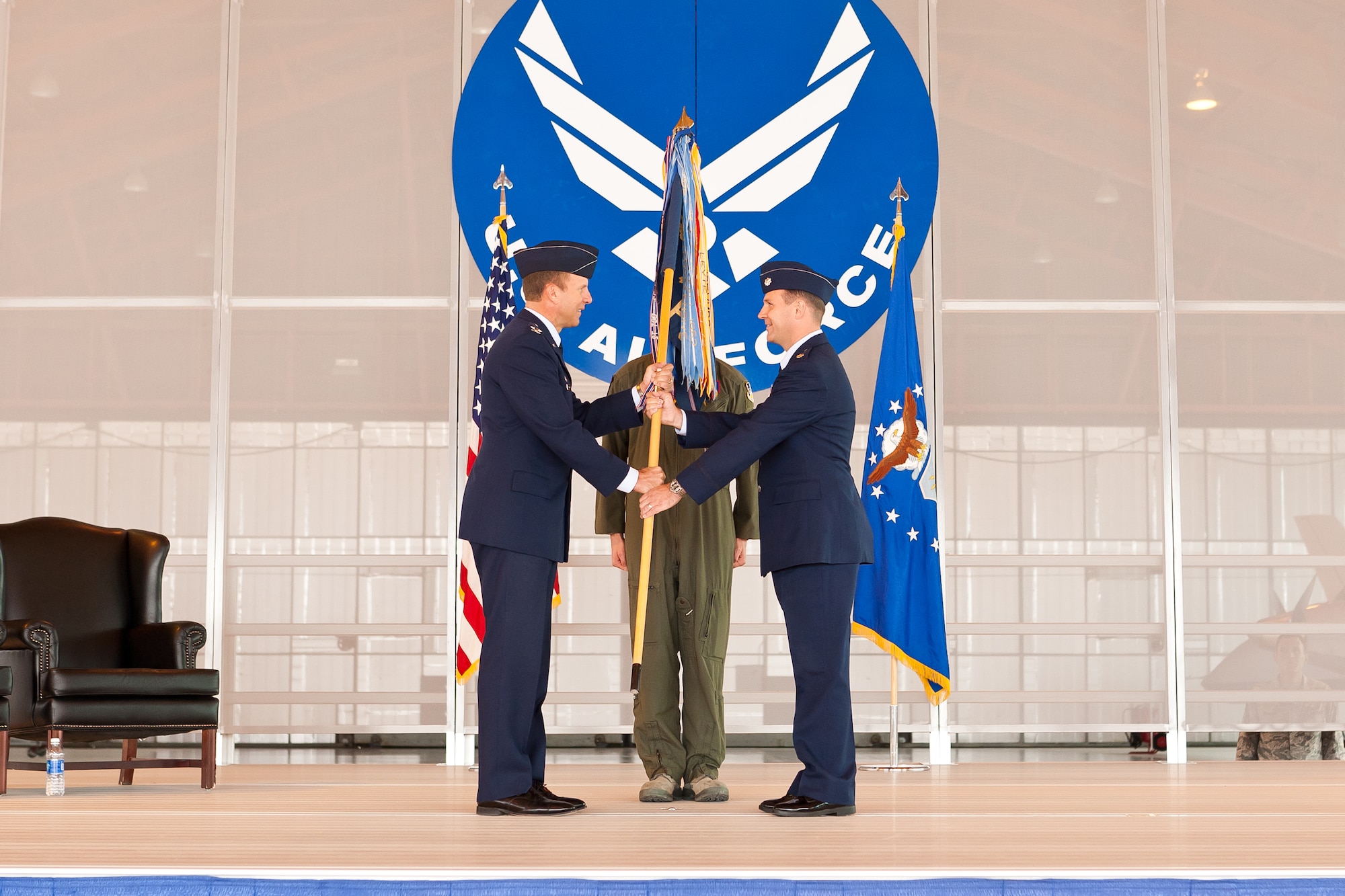 Colonel Kenneth Johnson, 49th Operations Group commander, hands the 9th Attack Squadron’s guidon to Lt. Col. Jeffrey Patton, 9th Attack Squadron commander at Holloman Air Force Base, N.M., Sept. 28. The exchanging of the guidon symbolizes Patton assuming command of the newly-activated 9th Attack Squadron. The 9th Attack Squadron was activated to supplement the 29th Attack Squadron as a remotely piloted aircraft training squadron. (Courtesy photo)