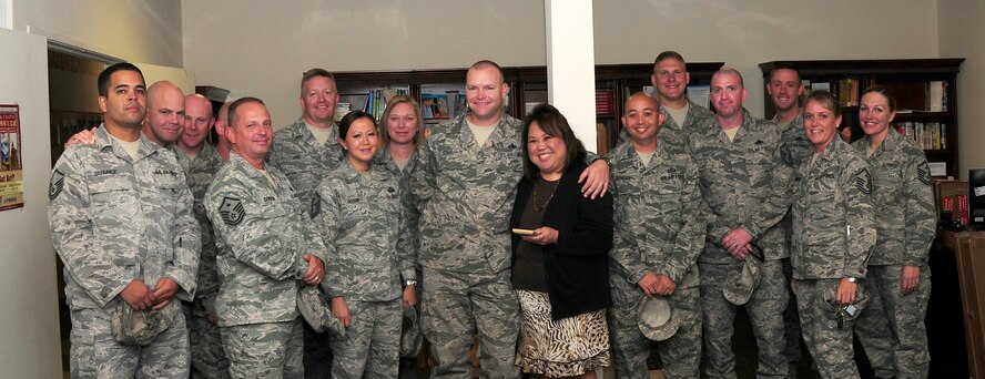 A group of Team Beale's first sergeants stand with Elizabeth Kim, 9th Force Support Squadron work life consultant, at the Airman & Family Readiness Center, Beale Air Force Base Calif., Oct. 3, 2012. Kim received the Diamond Recognition Award for her contributions to Airmen and their families. (U.S. Air Force photo by Senior Airman Allen Pollard)