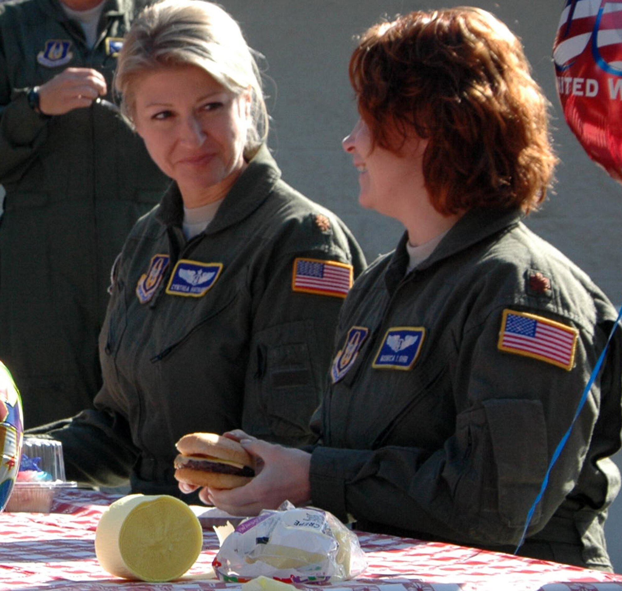 Maj. Cynthia Hathaway (left) and Maj. Monica Lohr, both flight nurses with the 446th Aeromedical Evacuation Squadron out of McChord Field, Wash., celebrate their homecoming at a squadron cookout, Oct. 3, after being deployed from numerous locations around the world. About 30 flight nurses, Medical Service Corps officers, and flight medics had been supporting Operation Enduring Freedom since April. (U.S. Air Force photo by Sandra Pishner) 