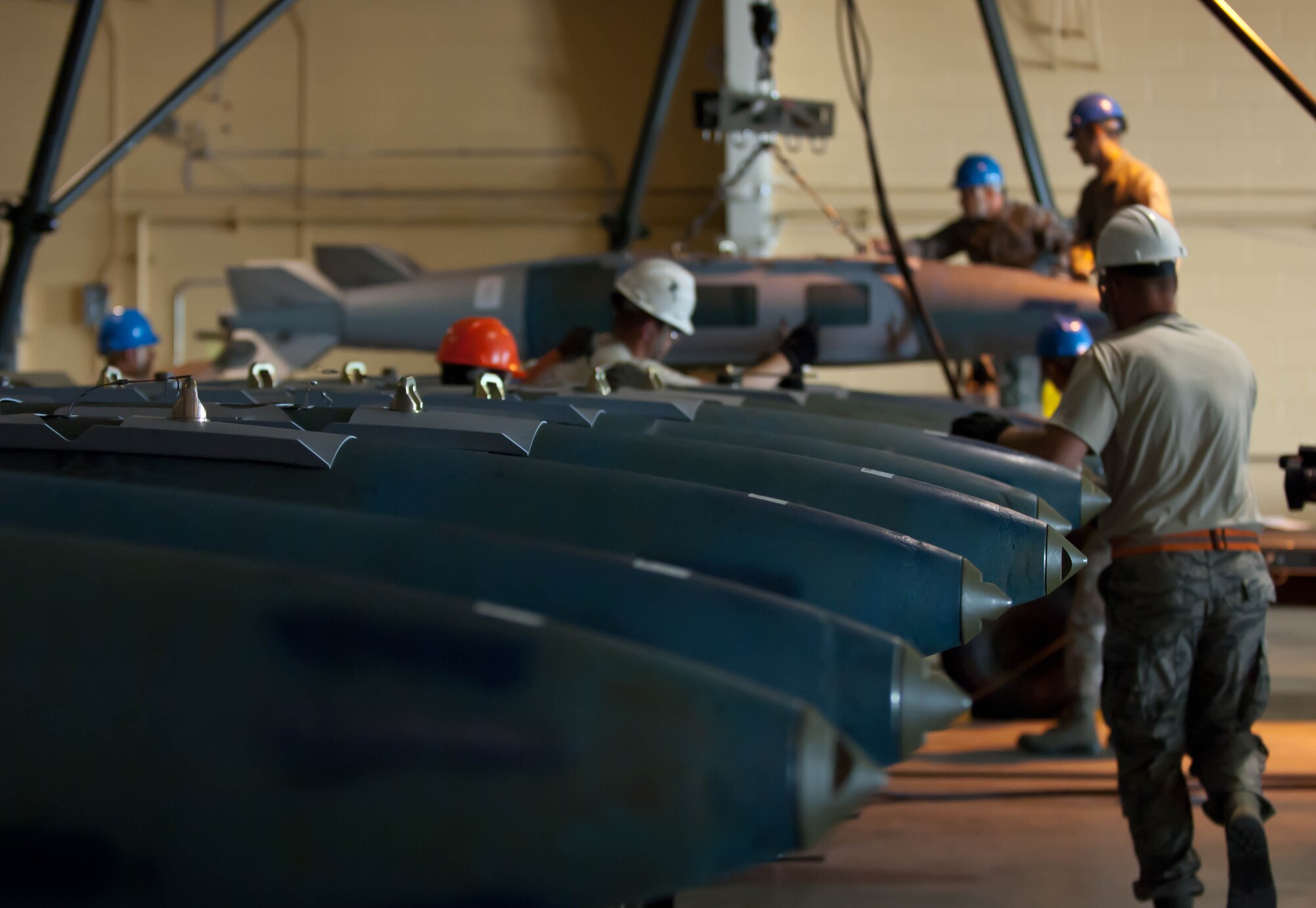 Airman 1st Class Christian Peterson, Senior Airman Cameron Smith, and Staff Sgt. Joshua Gott, 28th Munitions Squadron line members, assemble and load guided bomb units during the Global Strike Challenge at Ellsworth Air Force Base, S.D., Oct. 1, 2012. Global Strike Challenge is designed to improve the Air Force’s combat capabilities through competition and recognizing outstanding personnel and teams. (U.S. Air Force photo by Airman 1st Class Zachary Hada/Released)