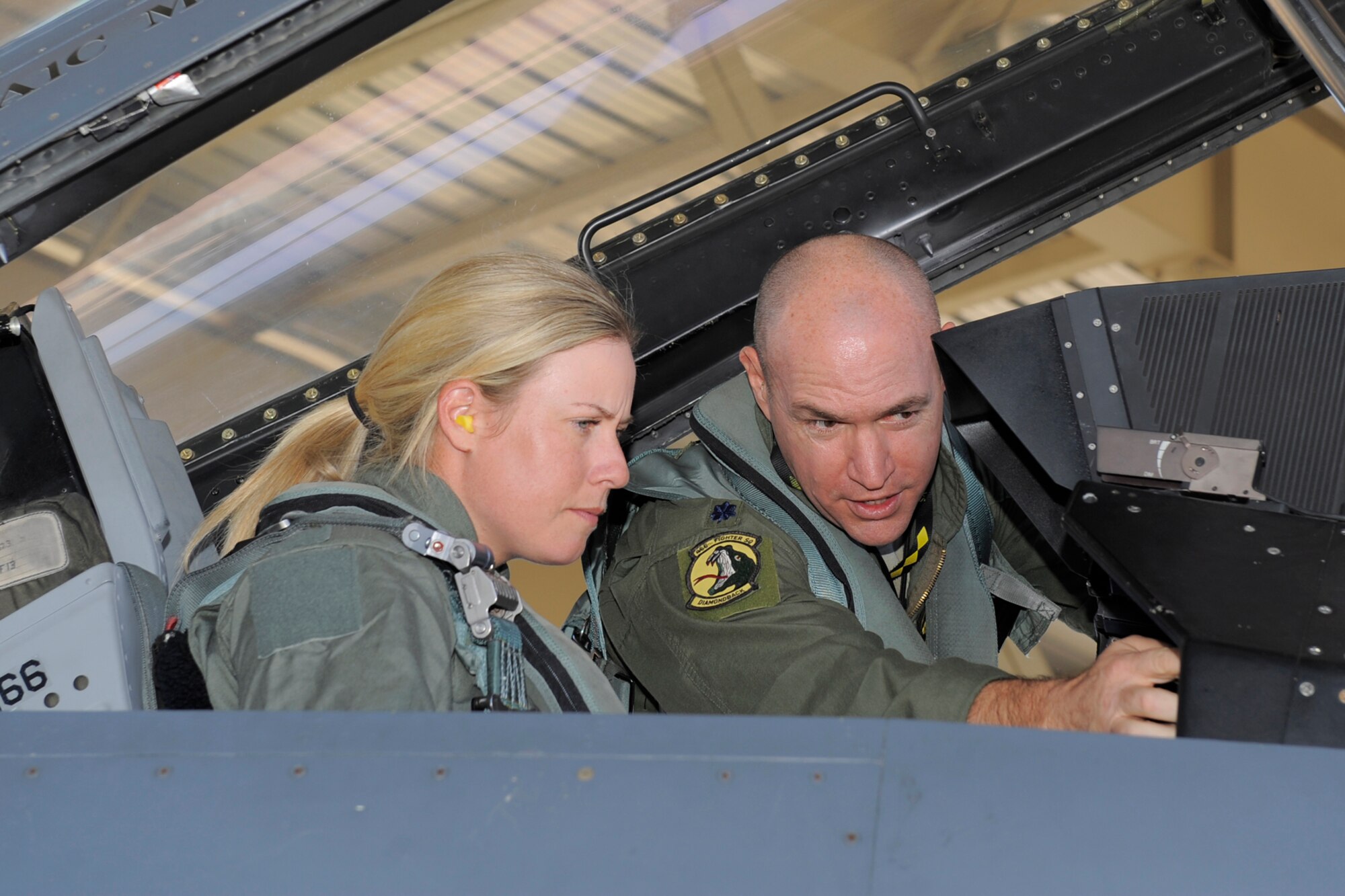 Lt. Col. Jim "Grata" Greenwald, 419th Fighter Wing, familiarizes Brittany Lincicome, LPGA Tour professional golfer, with the F-16 Fighting Falcon's cockpit and backseat instrument panels Oct. 2. Lincicome visited Hill Air Force Base, Utah, Oct. 1-2 to support a charity golf tournament and fly in an F-16. (Todd Cromar/U.S. Air Force)
