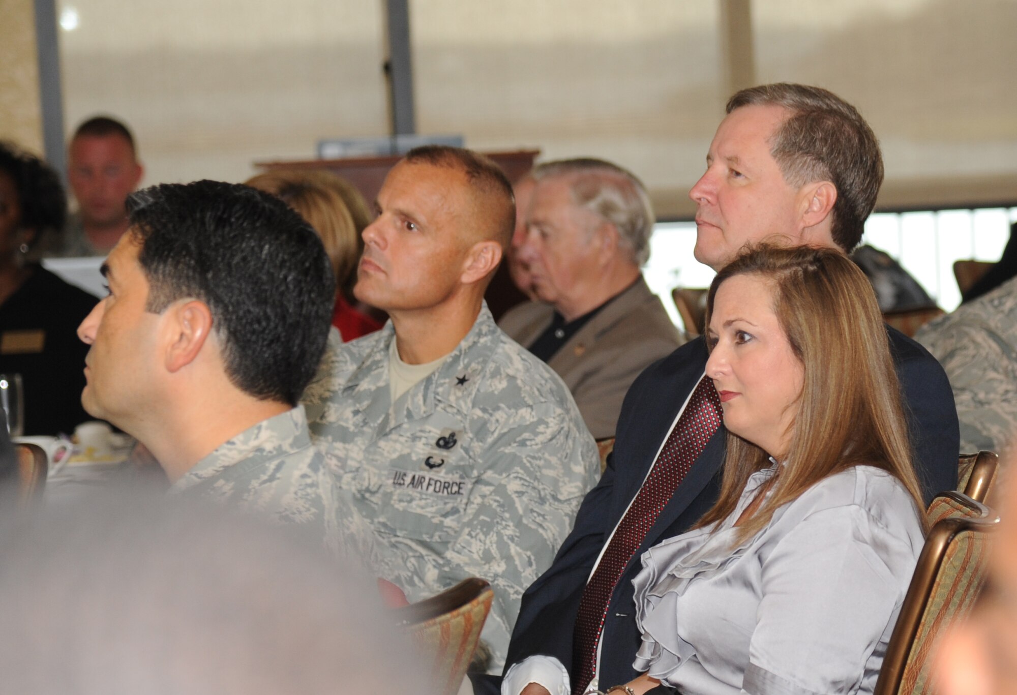 Emily Burke, Biloxi Chamber of Commerce president, and Vincent Creel, Public Affairs manager for the City of Biloxi, sit at the head table with Col. Rene Romero, 81st Training Wing vice commander (left), and Brig. Gen. Brad Spacy, 81st TRW commander, at the Bay Breeze Event Center during the Biloxi Chamber of Commerce Morning Call Sept. 4, 2012, hosted by Keesler Air Force Base, Miss.  (U.S. Air Force photo by Kemberly Groue)
