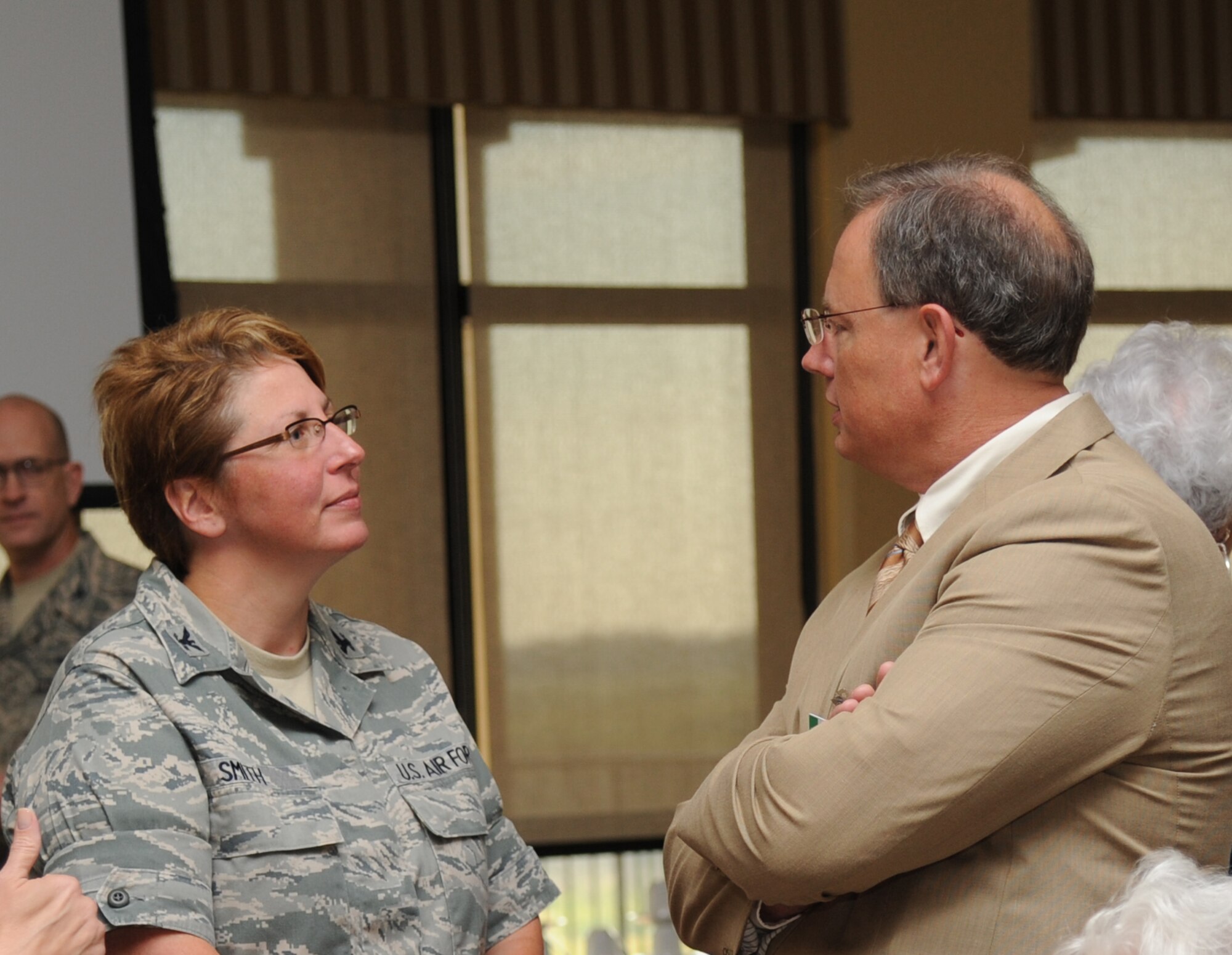 Col. Maureen Smith, 81st Training Group commander, speaks to Arthur McMillan, Superintendent of Biloxi Schools, at the Bay Breeze Event Center during the Biloxi Chamber of Commerce Morning Call Sept. 4, 2012, hosted by Keesler Air Force Base, Miss.  (U.S. Air Force photo by Kemberly Groue)