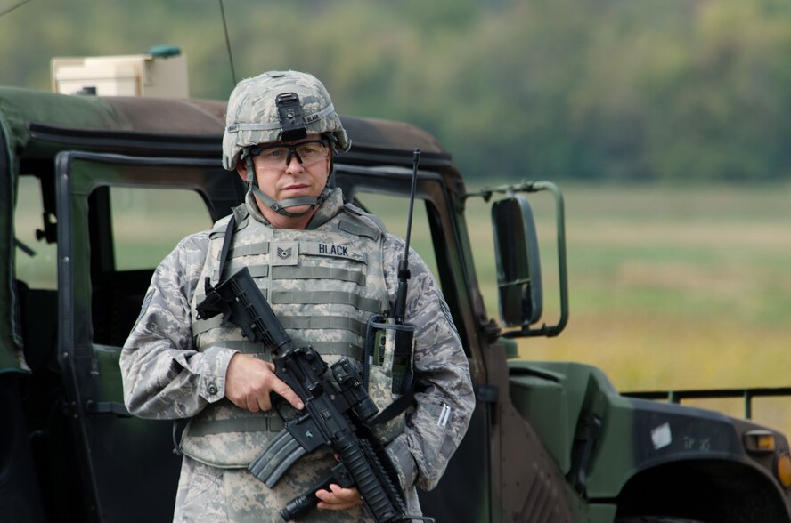 Tec h. Sgt. Christopher Black, 139th Security Forces Squadron, stands ready during a mock deployment scenario at Rosecrans Air National Guard Base, St. Joseph, Mo., Sept. 28, 2012. Members of the Missouri Military Preparedness and Enhancement Commission and other local civic leaders witnessed an airdrop demonstration hosted by the 139th Airlift Wing. (Missouri Air National Guard photo by Staff Sgt. Michael Crane)