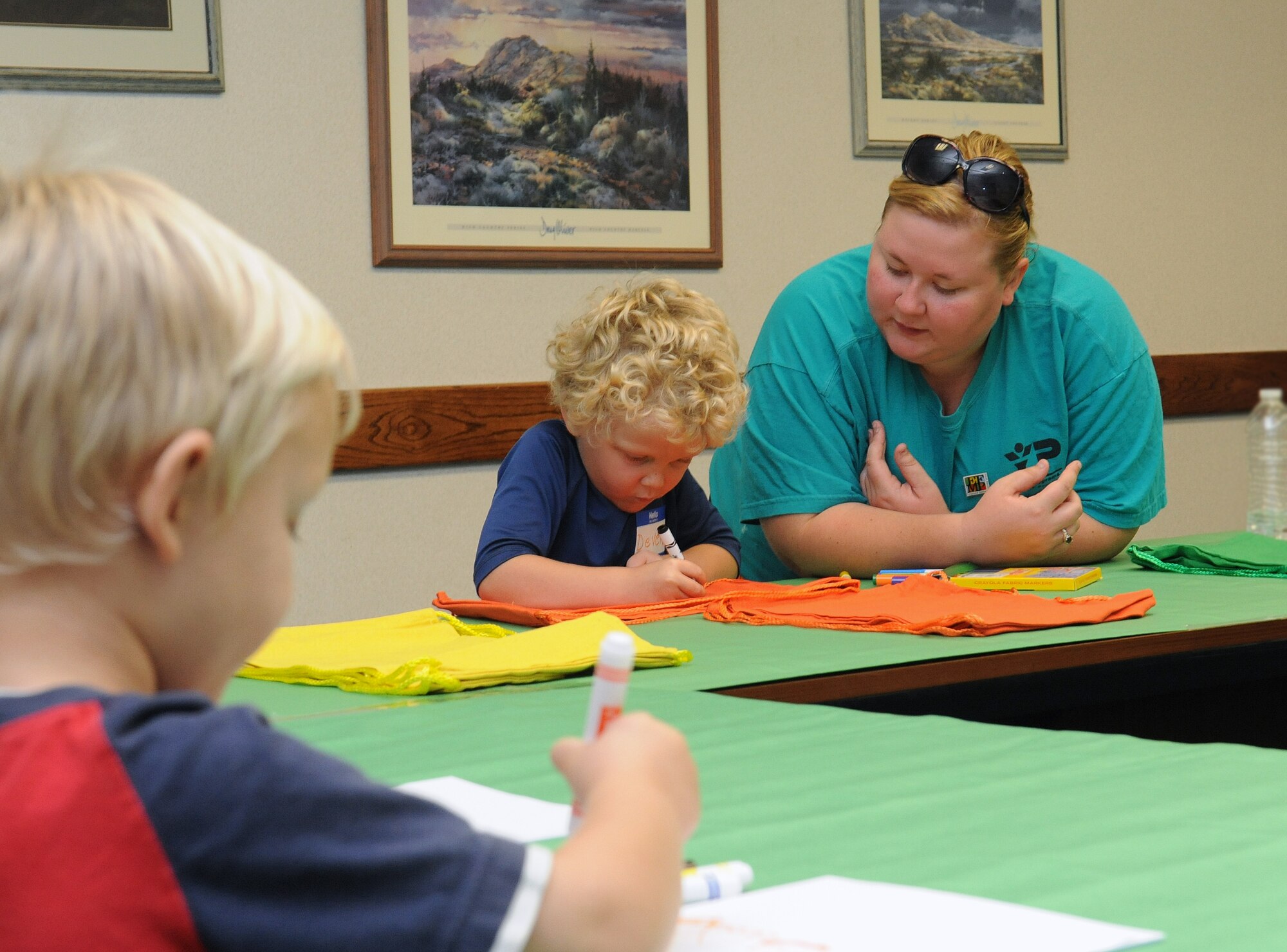 Jaynee Postlethwait (right), volunteer,  works on arts and crafts with Deven (middle) and Branden Crane (left)  Sept. 29,  2012, during the Special Needs Fair at Beale Air Force Base, Calif. The event introduced families and children with special needs to resources and other families in similar situations. (U.S. Air Force photo by Mr. Sean Bhakta/Released)   
