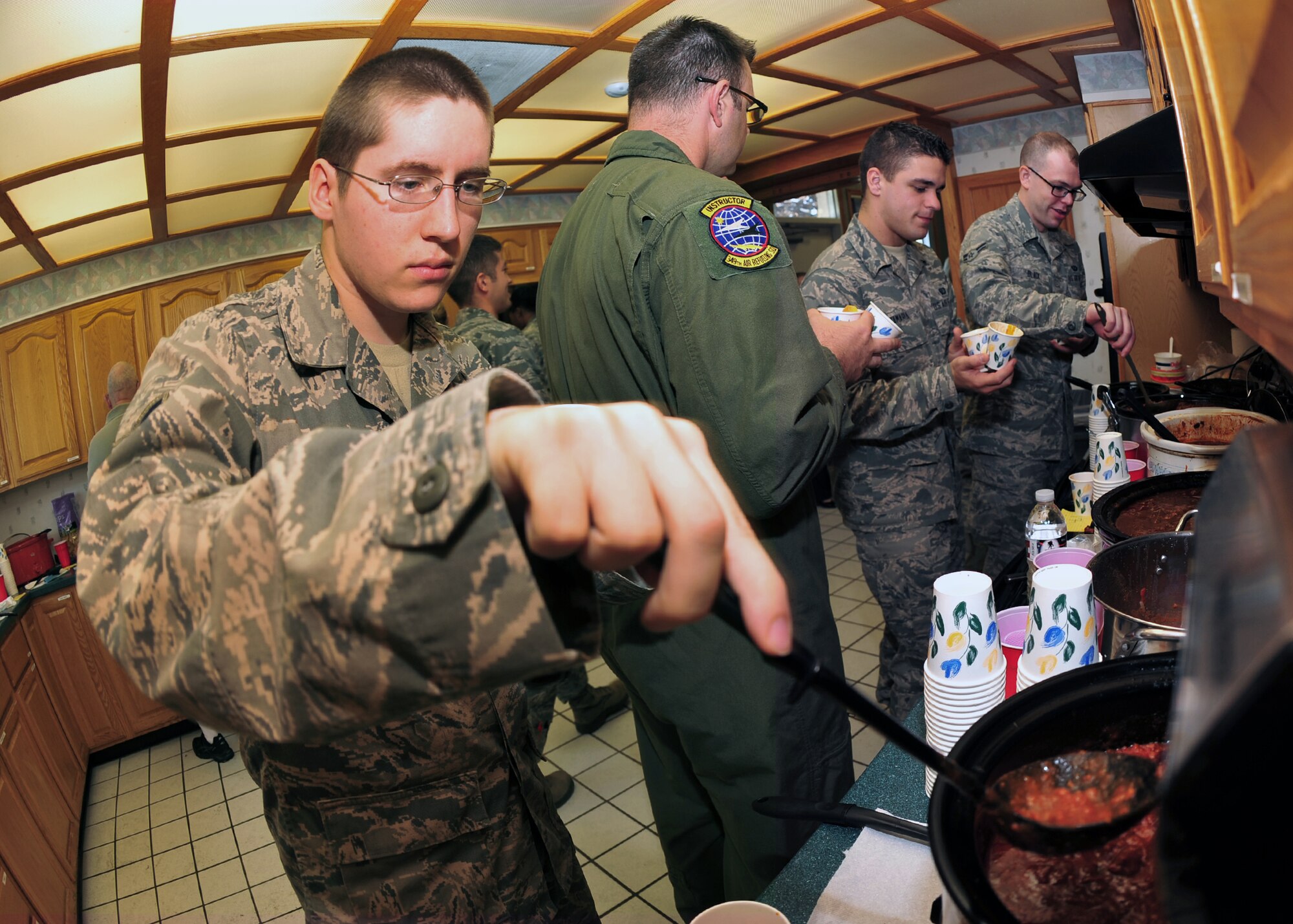 Airman 1st Class Jake Frisch, 350th Air Refueling Squadron boom operator, serves himself a bowl of chili during the Combined Federal Campaign kick-off event Oct. 1, 2012, McConnell Air Force Base, Kan. CFC base representatives gathered McConnell members to judge a chili cook-off and distribute CFC information. The CFC runs from from Sept. 1 through Dec. 15 and allows federal employees to donate to the charity of their choice. McConnell members can contact their squadron CFC representative to donate. (U.S. Air Force photo/Staff Sgt. Maria A. Ruiz)