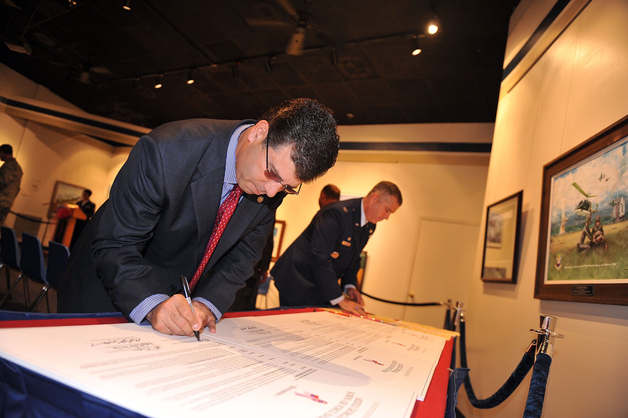 Warner Robins Mayor, Chuck Shaheen, Col. Mitchel Butikofer, installation commander; and other base and community leaders signed a proclamation Sept. 26 at the Museum of Aviation designating October 2012 as the third annual Triple Ribbon Month. (U. S. Air Force photo/Tommie Horton)