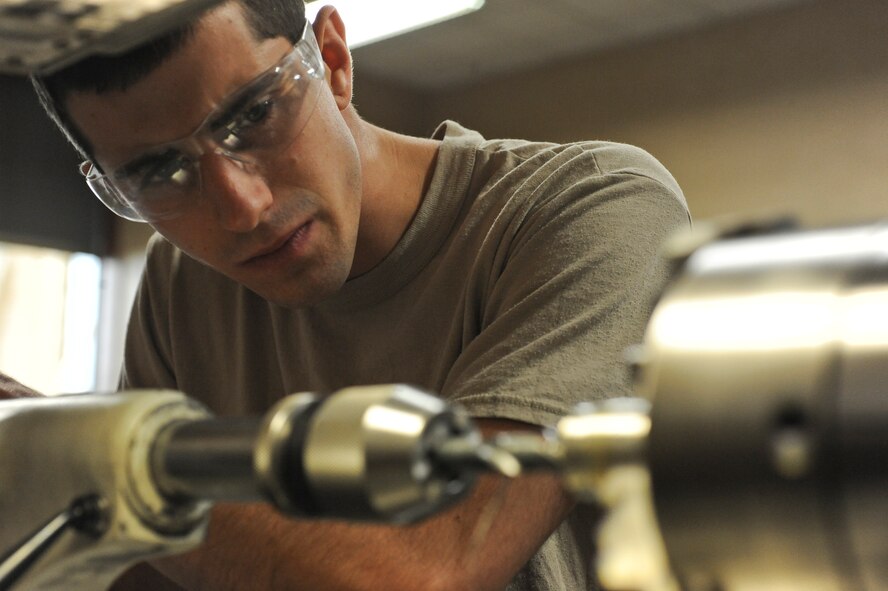 Airman 1st Class Cameron Arruda, 2nd Maintenance Squadron metals tech journeyman, uses a lathe to bore a hole through a weapons pylon bushing on Barksdale Air Force Base, La., Oct. 4. Arruda must gradually switch each drill bit out for a larger one in order to bore the hole correctly. Team Barksdale is comprised of dedicated individuals who are highly trained, well-equipped and ready to work with the nation's most powerful weapon system to the level of perfection the American people expect and deserve. (U.S. Air Force photo/Senior Airman Micaiah Anthony)(RELEASED)