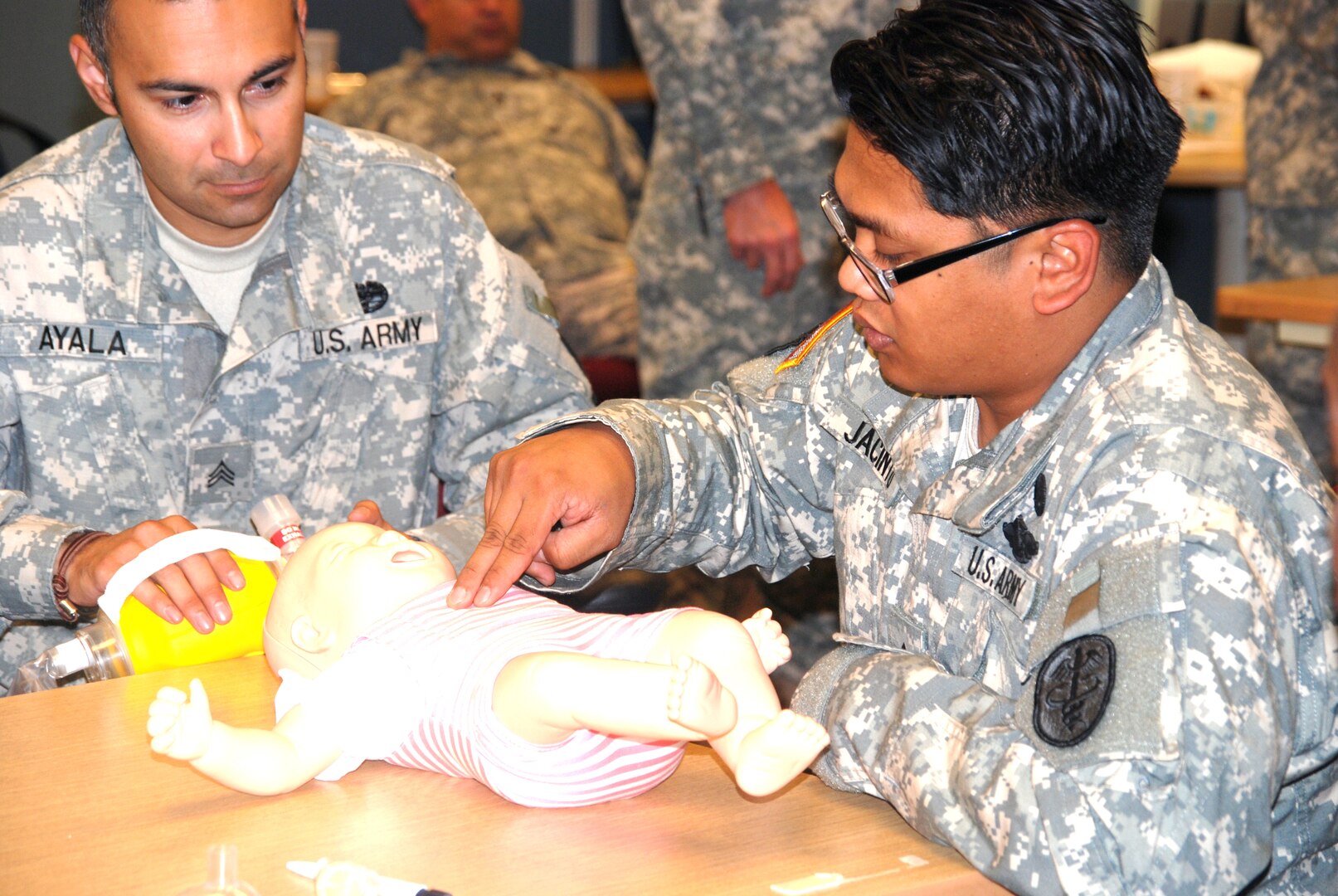 Combat medic wounded warriors Sgt. Vicente Ayala and Cpl. Aaron Jacinto perform cardiopulmonary resuscitation on a simulated baby mannequin during the basic life support segment of the 68W combat medic training at Joint Base San Antonio-Fort Sam Houston Sept. 11.
Photo by Marsha Huffman