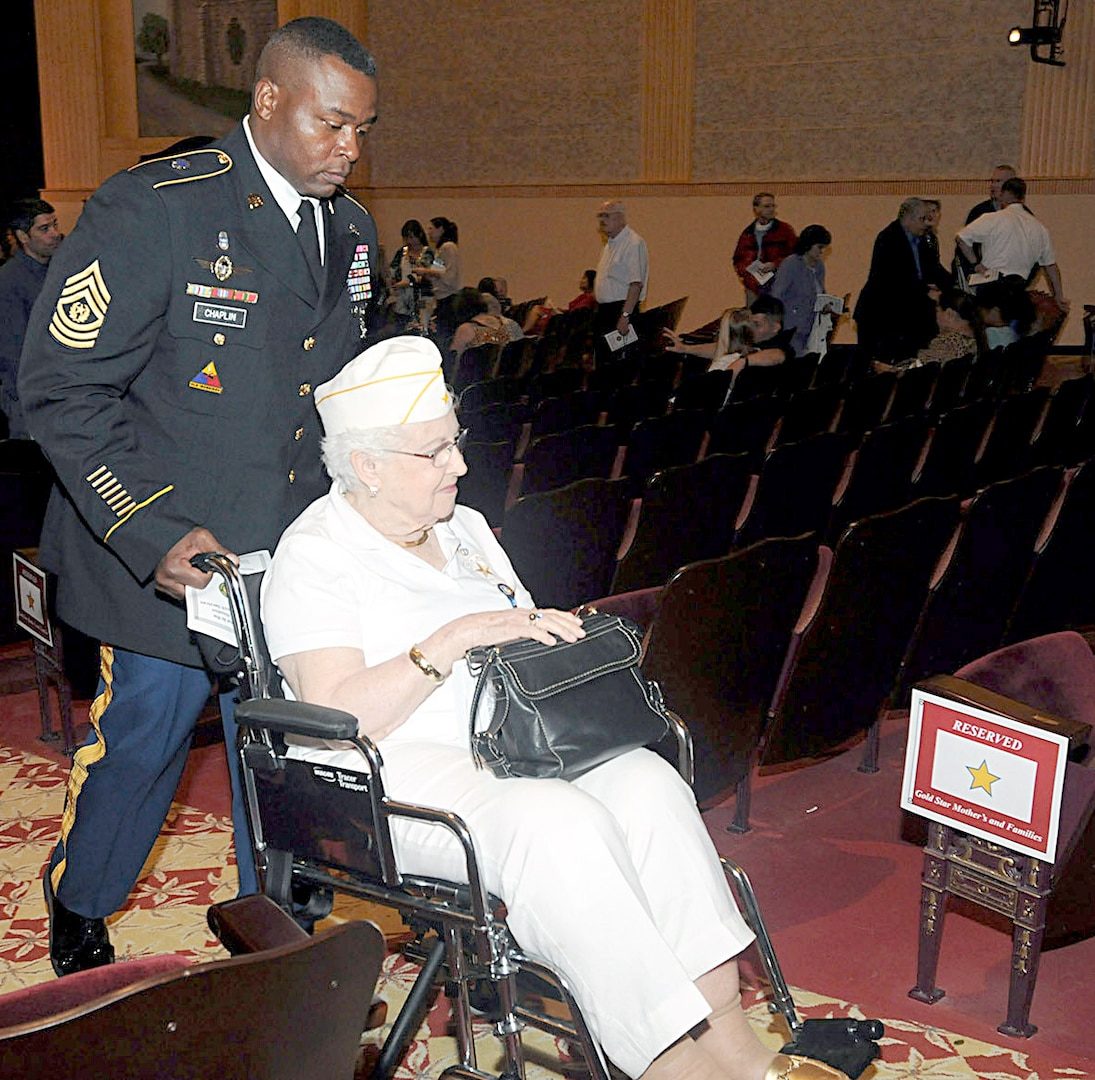 Command Sgt. Maj. Alvin Chaplin Sr., Headquarters, Headquarters Battalion, U.S. Army North, helps Gold Star Mothers Esther Campbell Gates out of the Fort Sam Houston Theater following the Survivor Outreach Service Ribbon Cutting ceremony Sept. 29. Gates’ son, Spc. 4 Keith Campbell, was killed in action in Vietnam in February of 1967. The post library is dedicated in his name.
Photo by Sgt. 1st Class Christopher DeHart
