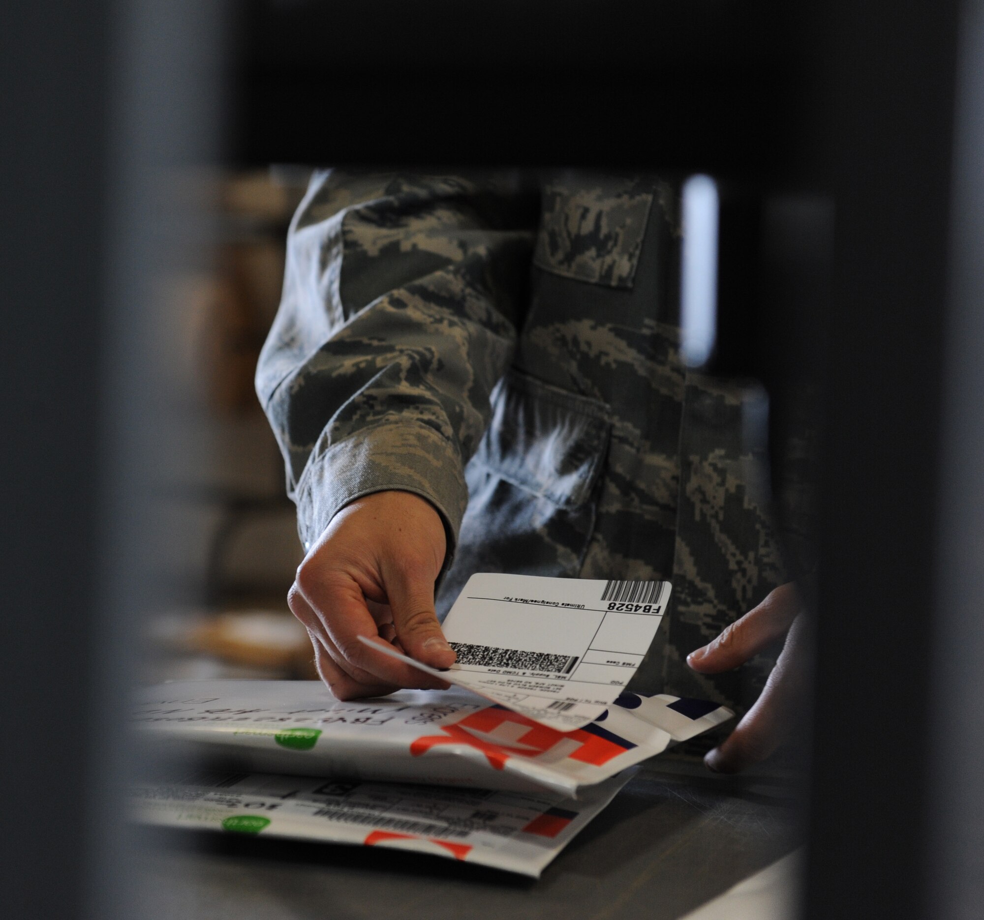 WHITEMAN AIR FORCE BASE, Mo. -- Airman 1st Class Michael Evseff, 509th Logistics Readiness Squadron packing and crating clerk, puts mailing addresses on packages, Oct 1. (U.S. Air Force photo/Airman 1st Class Bryan Crane) (Released)