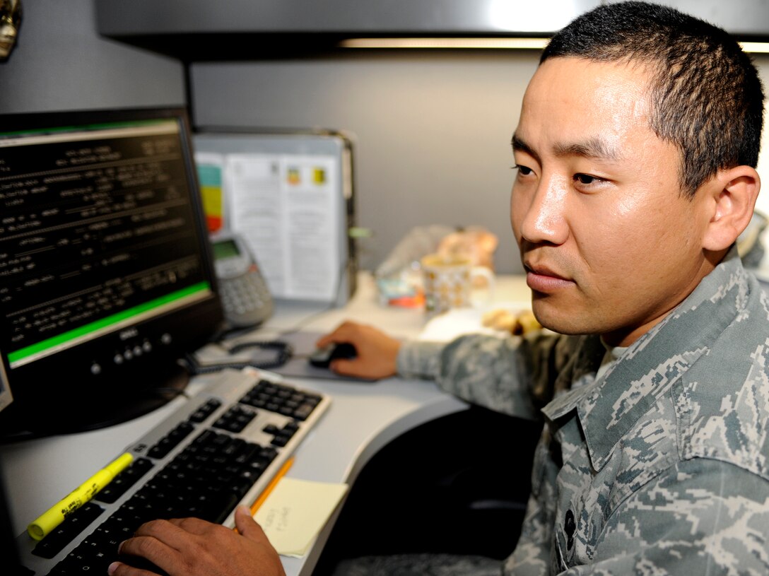 Senior Airman Tenzin Kunphel, 28th Comptroller Squadron financial analyst, transfers government purchase card responsibilities from one cardholder to another in the 28th CPTS office at the Rushmore Center on Ellsworth Air Force Base, S.D., Sept. 28, 2012. The 28th CPTS staff work to ensure GPC cardholders have the proper documentation to complete their purchases before Oct. 1, the end of the fiscal year. (U.S. Air Force photo by Airman Ashley J. Woolridge/Released)