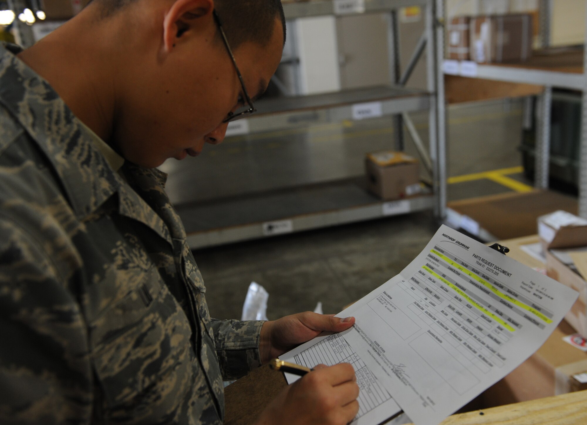 WHITEMAN AIR FORCE BASE, Mo. -- Airman Bing Yi Liu, 509th Logistics Readiness Squadron receiving clerk, documents that all parts were received from a shipment, Oct. 1. (U.S. Air Force photo/Airman 1st Class Bryan Crane) (Released)