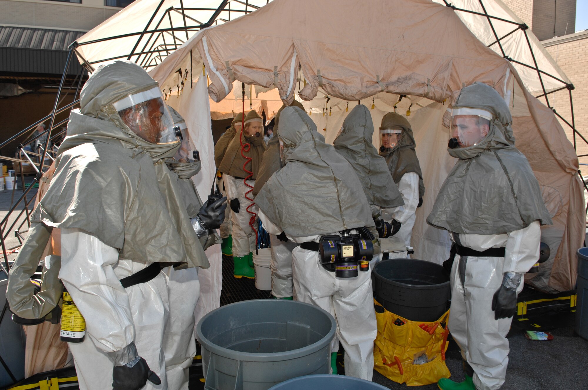 Airmen prepare a mock decontamination tent during a base-wide exercise. Exercises provide opportunities to validate training effectiveness and provides opportunities to make changes where needed with minimal risk to personnel and property. Tyndall will continue to hold a minimum of one exercise per quarter and scenarios will vary. (U.S. Air Force photo by Chris Cokeing)