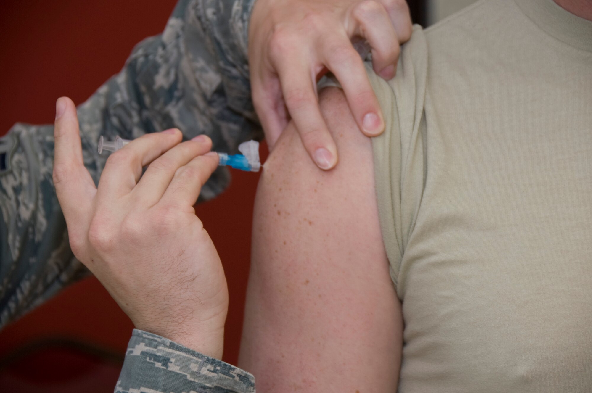 Senior Airman Sean Anderson, 379th Expeditionary Medical Group technician, administers an influenza vaccination to Master Sgt. Bobby Caldwell, 379th Expeditionary Force Support Squadron Lodging superintendent, Oct. 3, 2012. The 379th Air Expeditionary Wing received more than 9,000 flu vaccines to distribute to all U.S. service members, coalition forces and Department of Defense civilian personnel to prepare for the upcoming flu season. (U.S. Air Force photo/Senior Airman Bryan Swink)