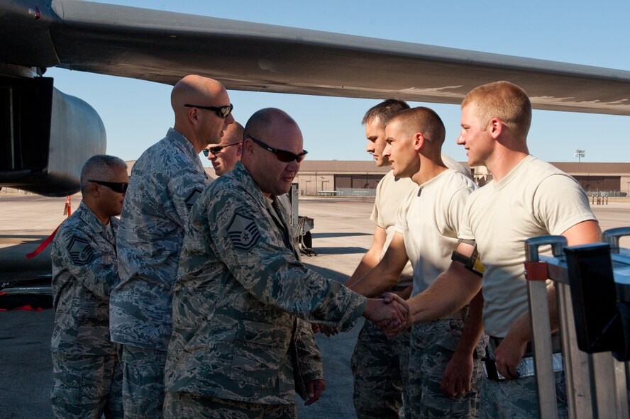 Airmen of the 28th Aircraft Maintenance Squadron are congratulated by evaluators after completing their portion of the Global Strike Challenge at Ellsworth Air Force Base, S.D., Oct. 1, 2012. Four load crew members and two crew chiefs prepared many weeks for this one day of competition during which career field specialists evaluated their operational success, skills and mission readiness. (U.S. Air Force photo by Airman 1st Class Kate Thornton-Maurer/Released)