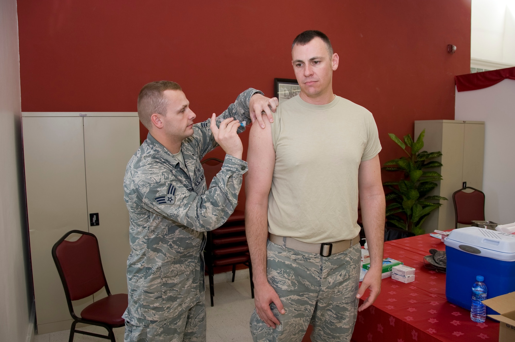 Senior Airman Sean Anderson, 379th Expeditionary Medical Group technician, administers an influenza vaccination to Master Sgt. Bobby Caldwell, 379th Expeditionary Force Support Squadron Lodging superintendent, Oct. 3, 2012. The 379th Air Expeditionary Wing received more than 9,000 flu vaccines to distribute to all U.S. service members, coalition forces and Department of Defense civilian personnel to prepare for the upcoming flu season. (U.S. Air Force photo/Senior Airman Bryan Swink)
