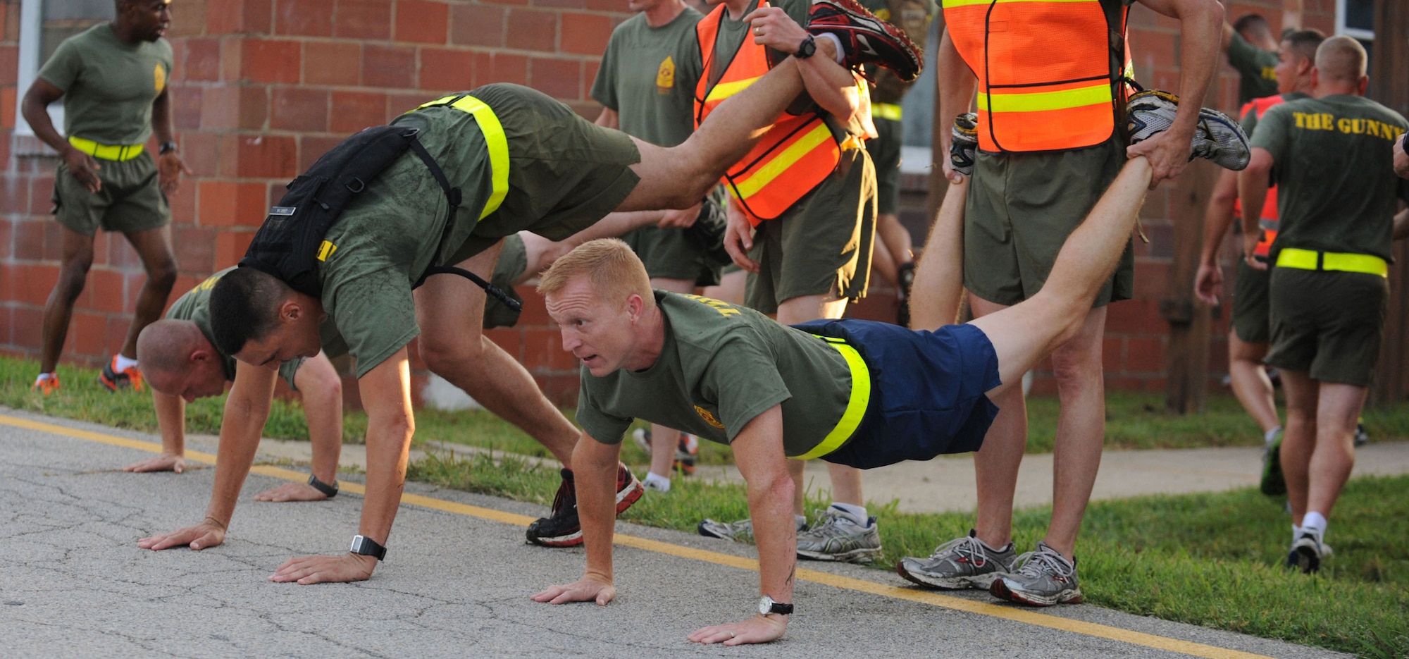 Air Force Master Sgt. Michael Noel, center, does elevated push-ups with his PME class as part of the U.S. Marine Corps Staff Noncommissioned Officer Academy Advanced Course at Marine Corps Base Quantico, Va., Sept. 14, 2012. Noel is the Secretary of the Air Force Public Affairs superintendent of force management at the Pentagon. (U.S. Air Force photo/Senior Airman Christina Brownlow)