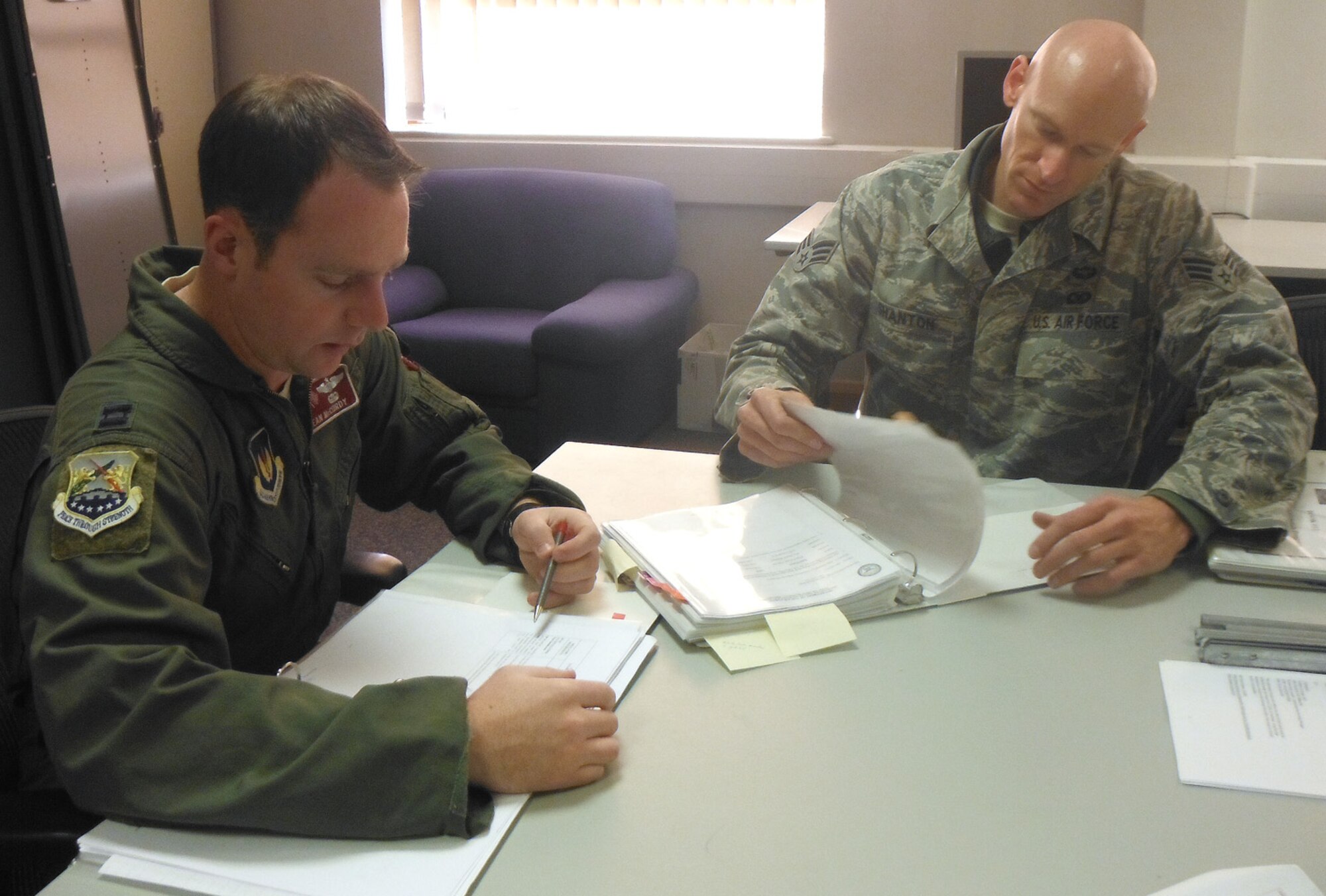 Capt. Sean McCurdy, 100th Air Refueling Wing inspector general inspections deputy, reviews hazardous waste checklists with Senior Airman Shane Shanton, 100th Operations Support Squadron Aircrew Flight Equipment hazardous waste manager, during the environmental, safety and occupational health compliance assessment management program assessment at Bldg. 809 Oct. 4, 2012. McCurdy assisted ESOHCAMP assessors during the internal inspection Oct. 1 to 4, which covered 20 different protocols including hazardous materials, water quality and storage tank management. (U.S. Air Force photo/Karen Abeyasekere)