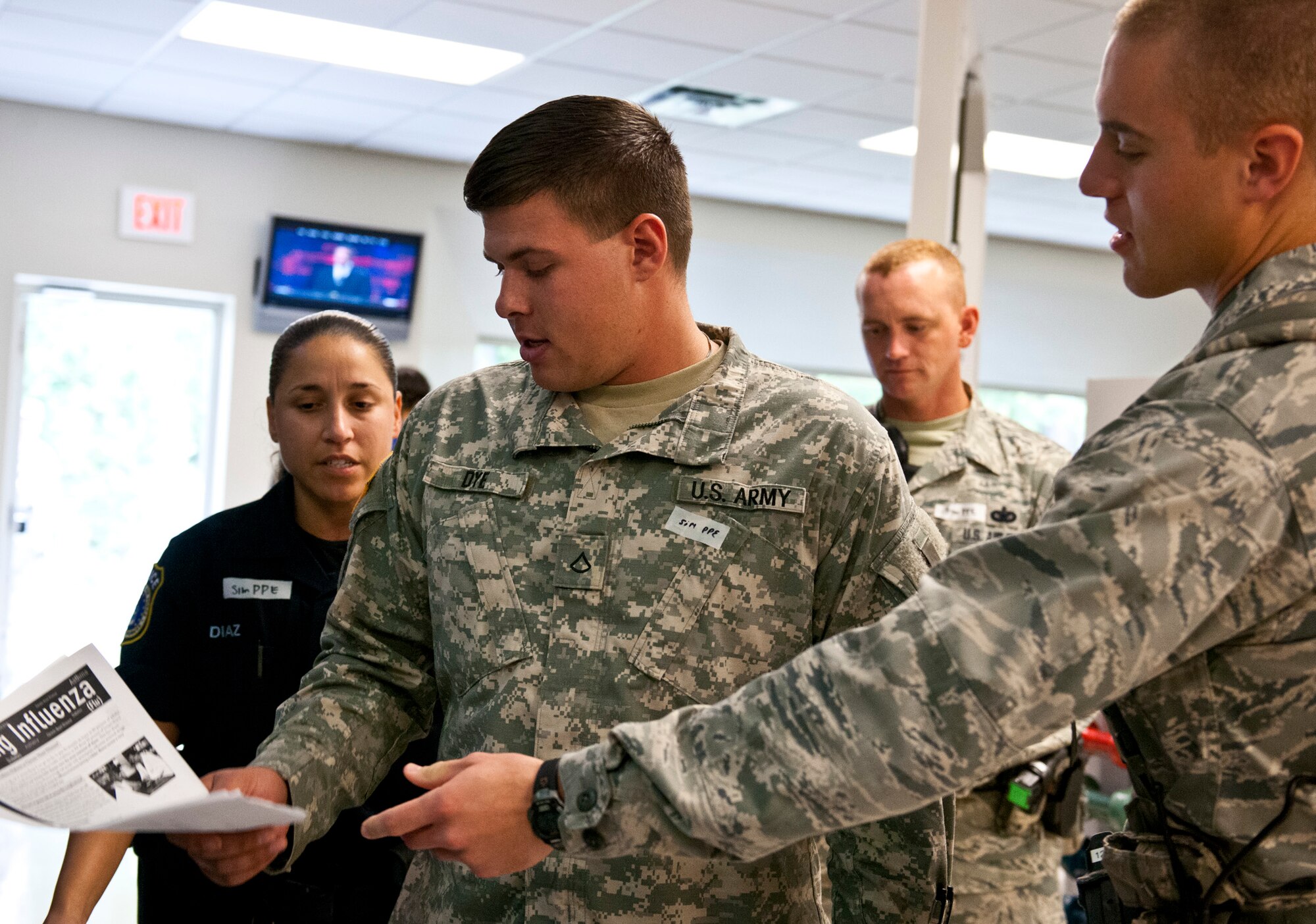 Security forces members step in when a simulated victim causes a scene at the processing line during a disease containment exercise at Eglin Air Force Base, Fla., Oct. 3.  The week-long exercise measured the base and specifically the 96th Medical Group’s response to a medical/biological emergency.  (U.S. Air Force photo/Samuel King Jr.)