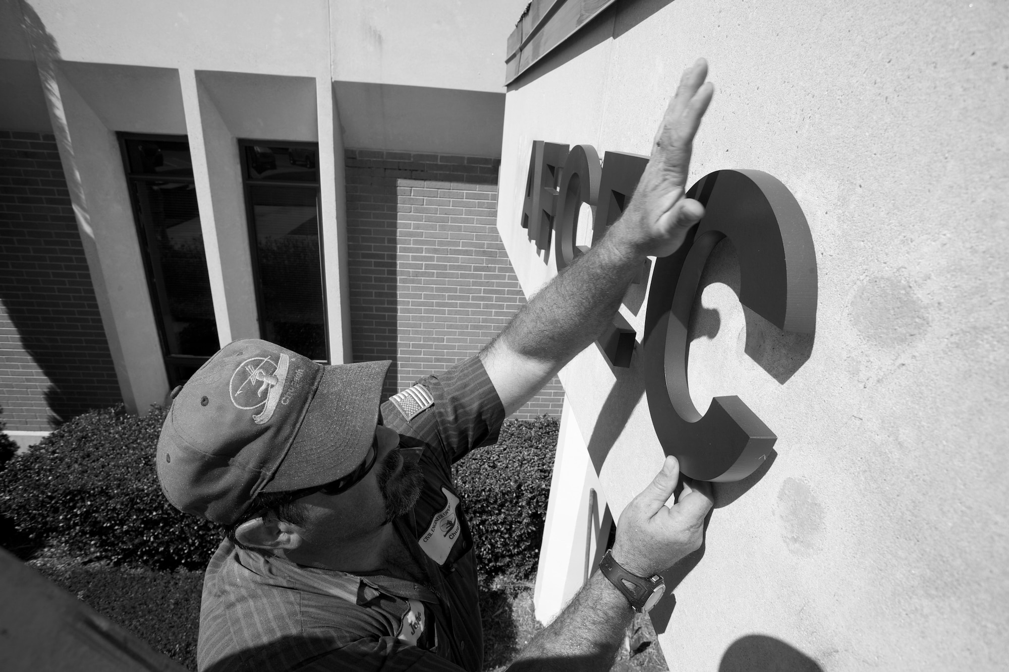 A worker changes the sign at Air Force Civil Engineer Support Agency to reflect the agency’s new name: the Air Force Civil Engineer Center or AFCEC. AFCESA merged with its sister units, the Air Force Center for Engineering and the Environment and the Air Force Real Property Agency to form a new unit called the Air Force Civil Engineer Center. (U.S. Air Force courtesy photo)