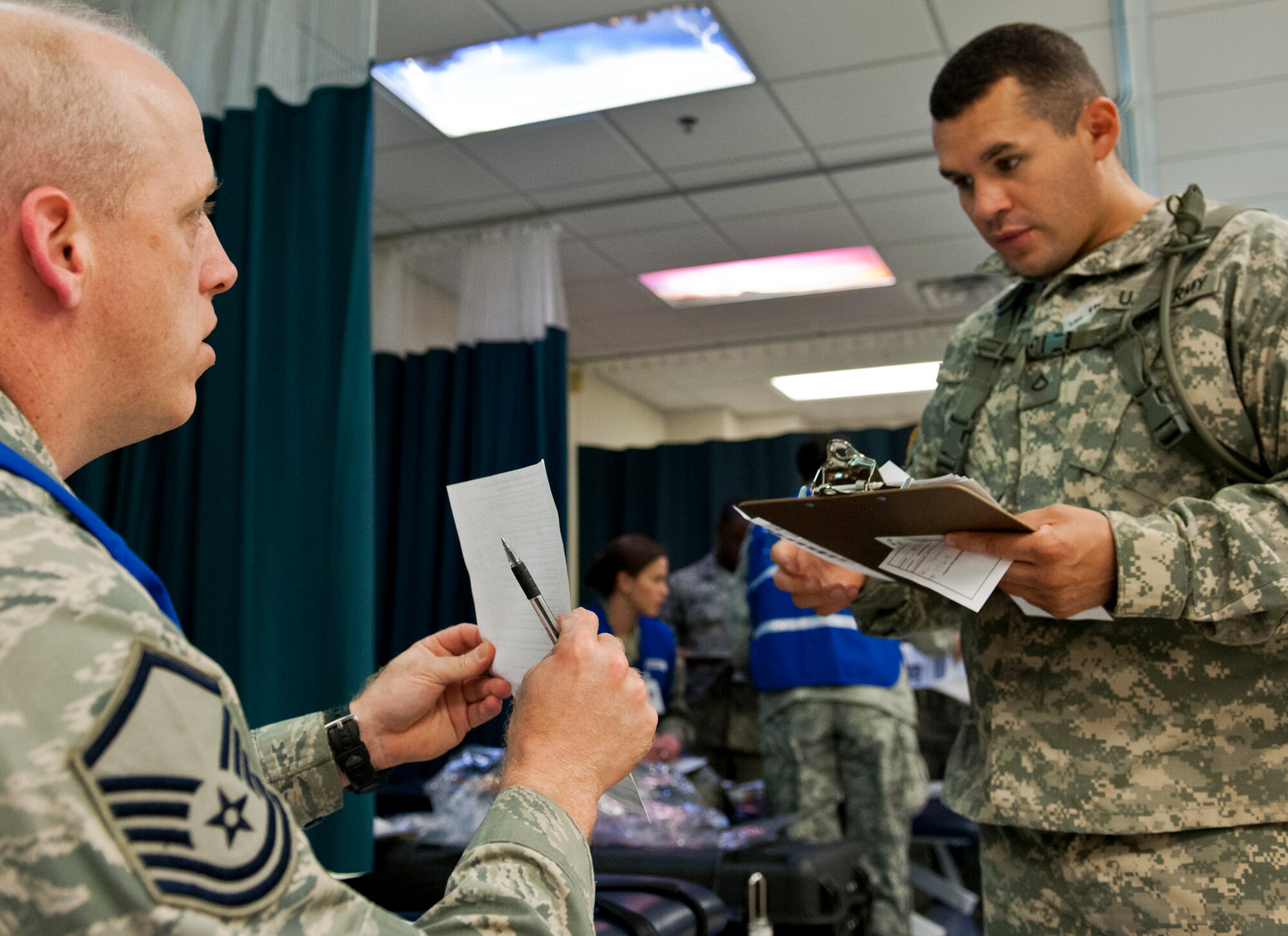 A Soldier with flu-like symptoms is briefed on what he should do next by a master sergeant with the 96th Medical Group during a disease containment exercise at Eglin Air Force Base, Fla., Oct. 3.  The week-long exercise measured the base and specifically the 96th Medical Group’s response to a medical/biological emergency.  (U.S. Air Force photo/Samuel King Jr.)