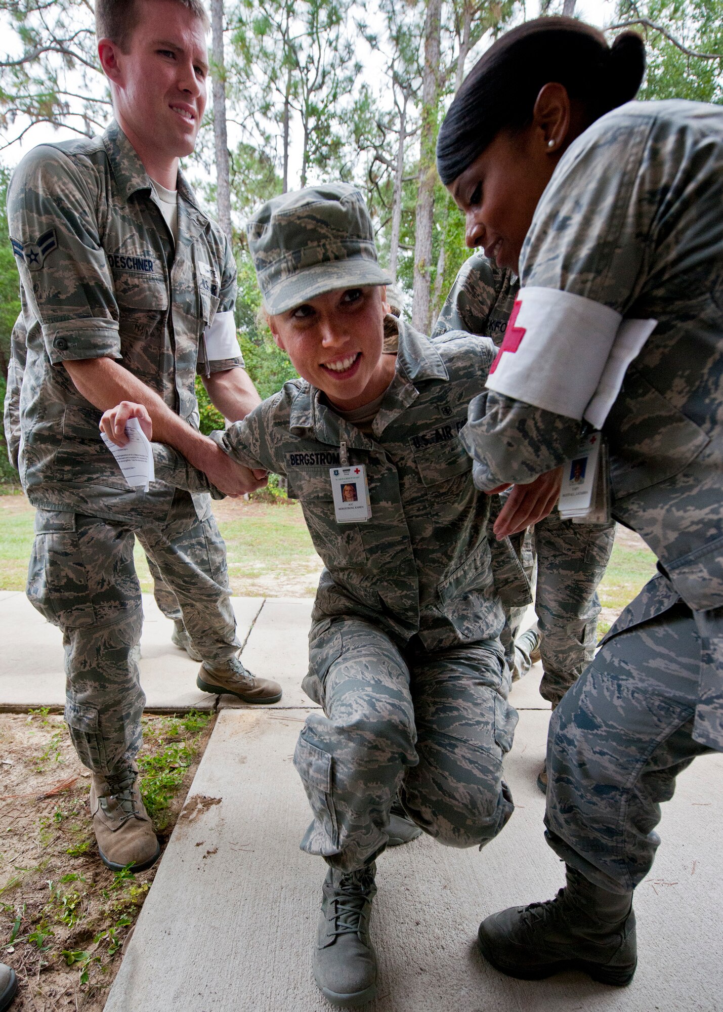 Medical staff members help up a simulated victim who fell ill outside of the processing line during a disease containment exercise at Eglin Air Force Base, Fla., Oct. 3.  The week-long exercise measured the base and specifically the 96th Medical Group’s response to a medical/biological emergency.  (U.S. Air Force photo/Samuel King Jr.)