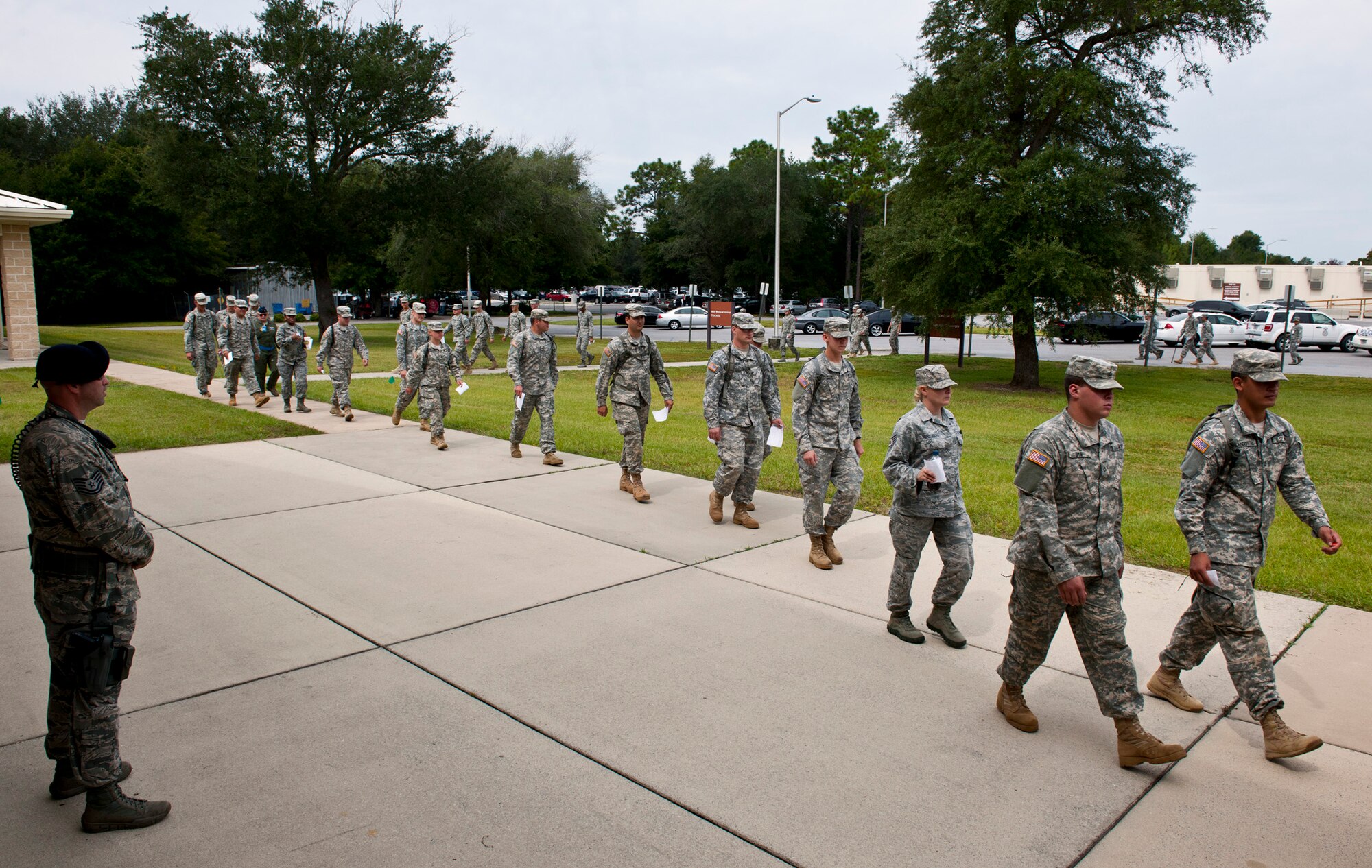 Simulated victims with flu-like symptoms walk to the hospital’s processing line during a disease containment exercise at Eglin Air Force Base, Fla., Oct. 3.  The week-long exercise measured the base and specifically the 96th Medical Group’s response to a medical/biological emergency.  (U.S. Air Force photo/Samuel King Jr.)