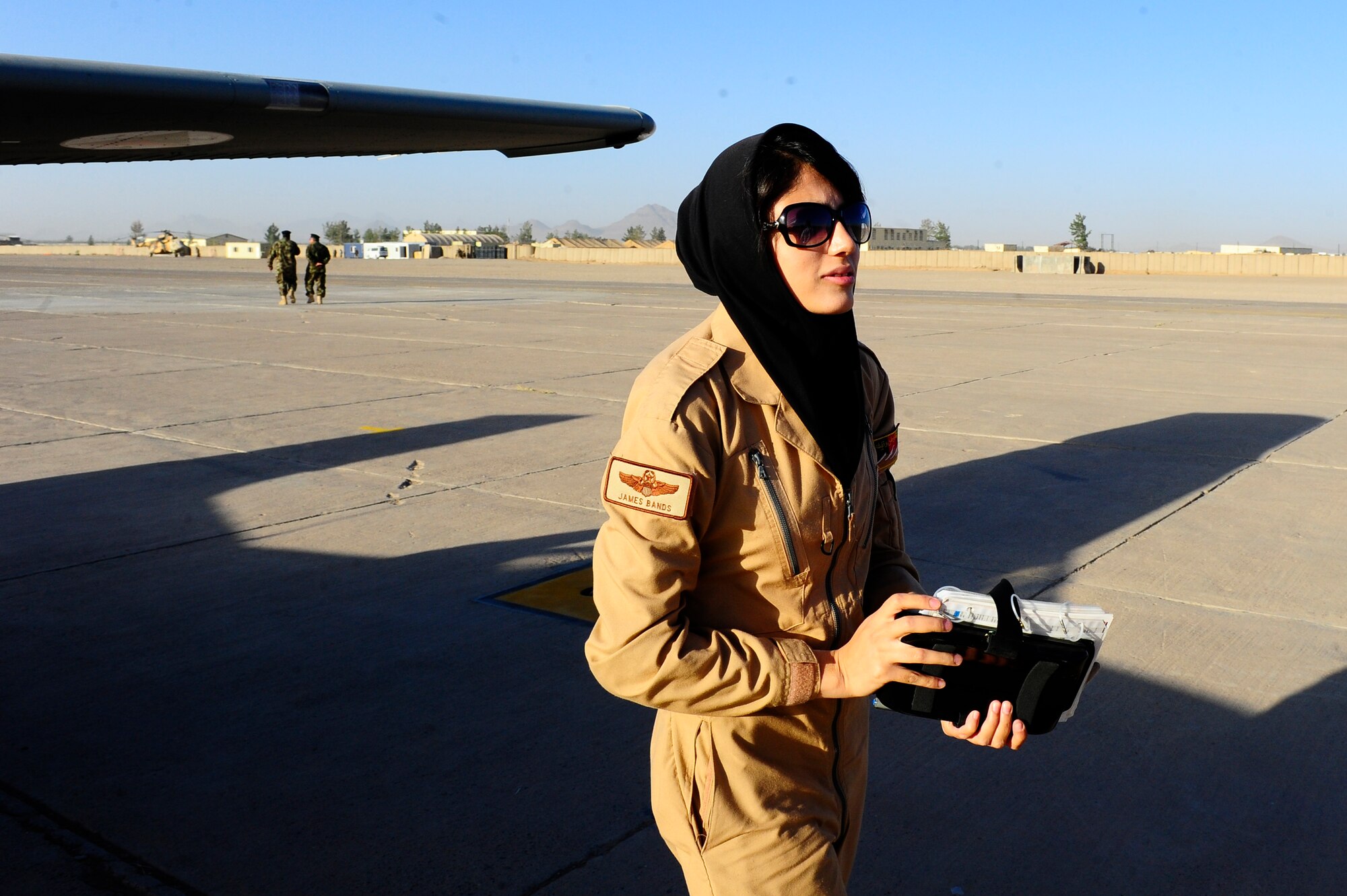 After completing her first solo flight in a Cesna-182, Afghan Air Force Lt. Nilofor Rhamani walks down the flight line of Shindand Air Base, Afghanistan, Sept. 30, 2012. Rhamani is the first Afghan female pilot to conduct all of her pilot training in Afghanistan.(U.S. Air Force photo by Staff Sgt. Melissa K. Mekpongsatorn)




