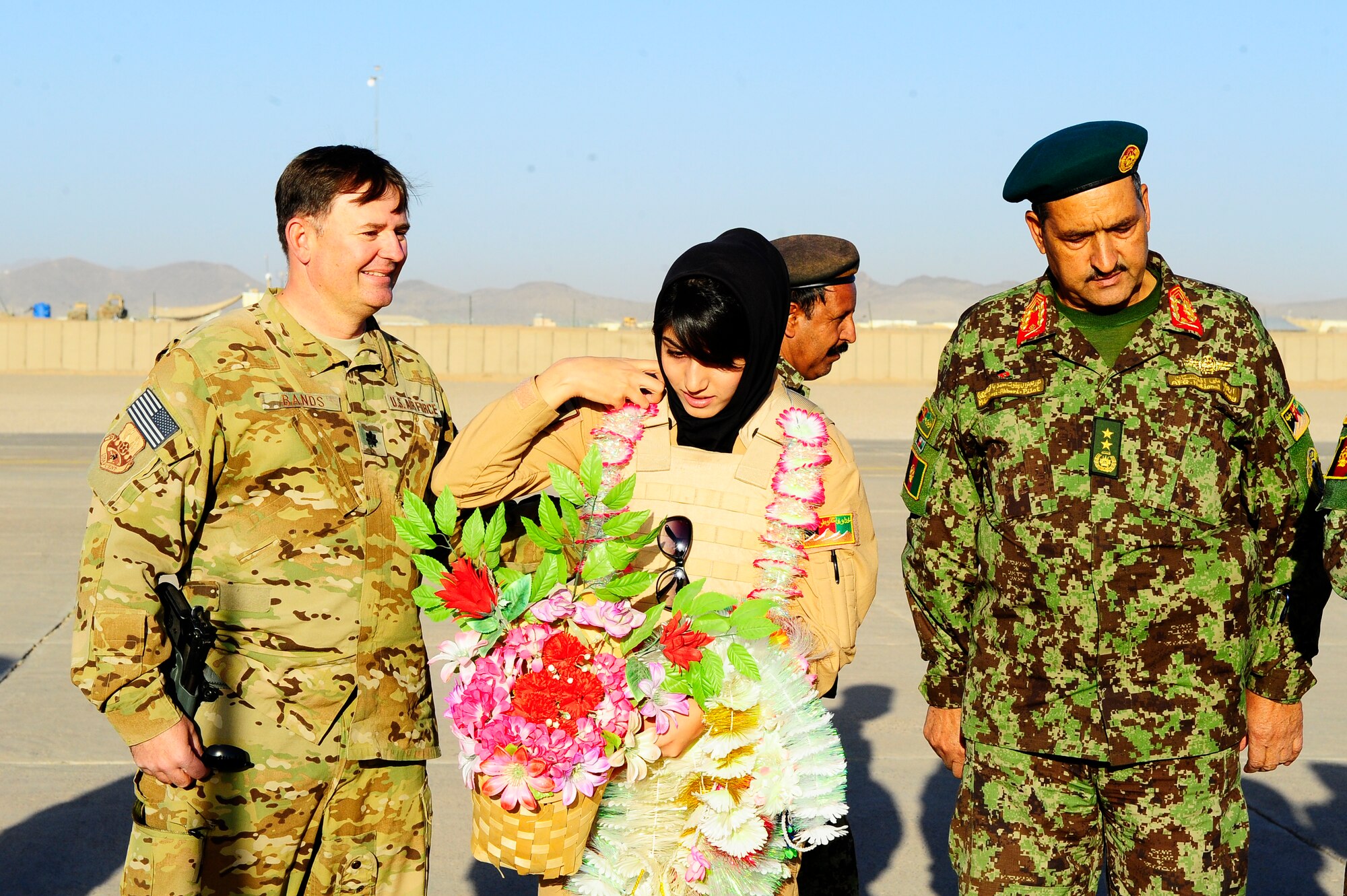 Afghan Air Force Lt. Nilofor Rhamani adjusts flowers after completing her first solo flight in a Cesna-182 Sept. 30, 2012 at Shindand Air Base, Afghanistan. To congratulate Rhamani on her flight, Afghan AF members placed several lei’s around her neck and gave her flowers. (U.S. Air Force photo by Staff Sgt. Melissa K. Mekpongsatorn)


