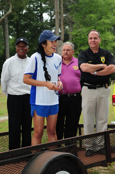 U.S. Air Force Col. Leslie Claravall, 4th Medical Group commander, speaks at the 4th Annual Wife Appreciation Run in Goldsboro, N.C., Sept. 29, 2012. Claravall led participants and volunteers in a chant in order to build excitement for the event. (U.S. Air Force photo/Airman 1st Class Aubrey Robinson/Released)