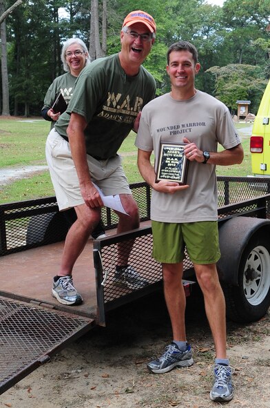 U.S. Air Force Lt. Col. Todd Dyer, 4th Fighter Wing director of staff, accepts a plaque during the 4th Annual Wife Appreciation Run in Goldsboro, N.C., Sept. 29, 2012. Dyer took first place in the male category for the 5k-run portion of the war on domestic violence event with a time of 17:45. (U.S. Air Force photo/Airman 1st Class Aubrey Robinson/Released)