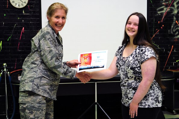 U.S. Air Force Col. Jeannie Leavitt, 4th Fighter Wing commander, presents a certificate to Brianna Buss, 12, at the youth center on Seymour Johnson Air Force Base, N.C., Sept. 25, 2012. Brianna’s vocal and piano performance of “Piano Man” won her the title of the Air Force’s most talented youth in the preteen category of “you got talent.” Brianna is the daughter of retired Master Sgt. Brian Buss. (U.S. Air Force photo/Airman 1st Class Aubrey Robinson/ Released)