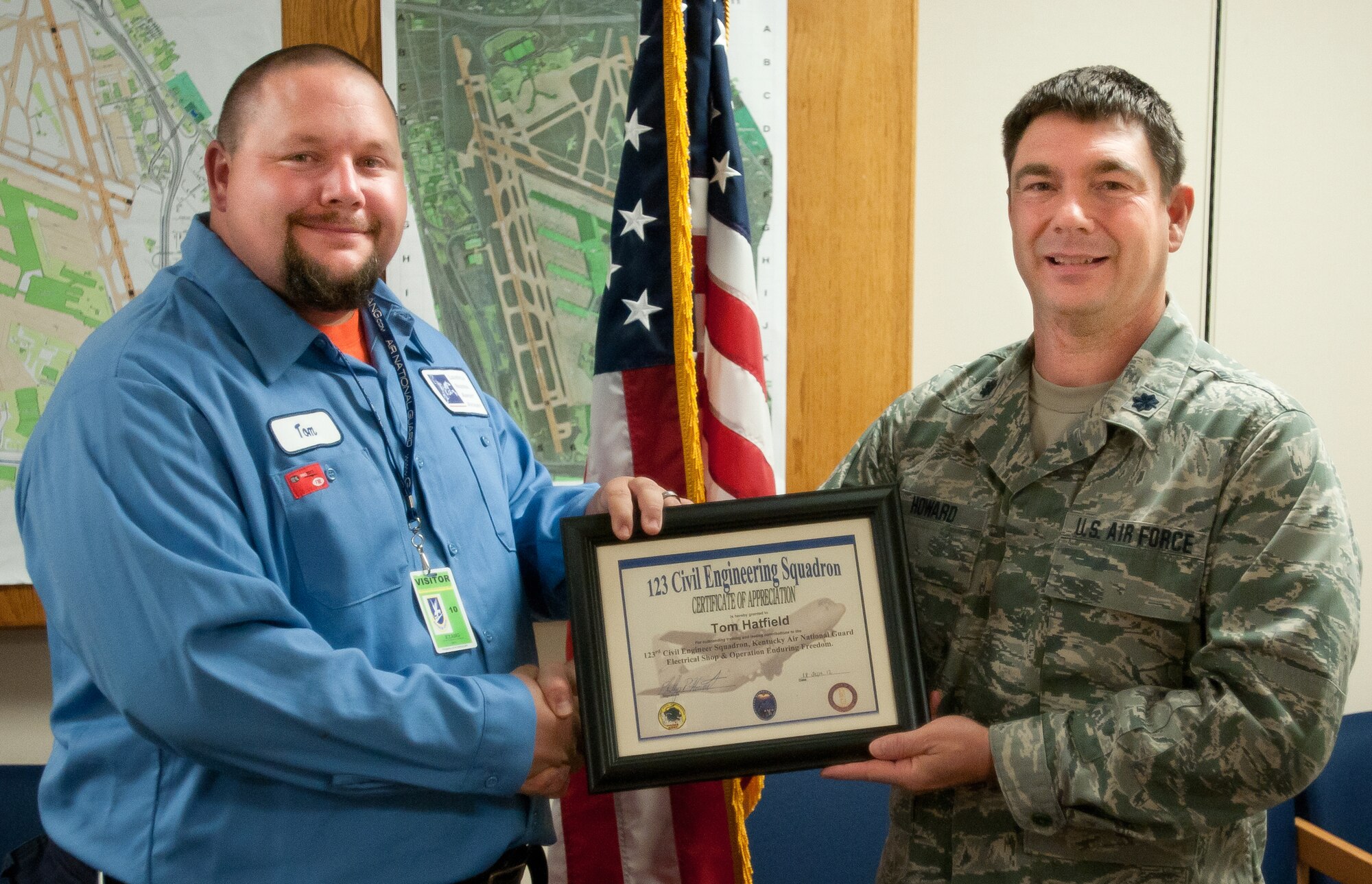 Kentucky Air National Guard Lt. Col. Phillip Howard, commander of the 123rd Civil Engineer Squadron, presents a certificate to Tom Hatfield, an airfield technician with the Louisville Regional Airport Authority in Louisville, Ky., on Sept. 21, 2012. Roy helped train Kentucky Air Guard civil engineers on the maintenance of commercial airfield lighting equipment, which enhanced their mission effectiveness during a 2011 deployment to Afghanistan. (Kentucky Air National Guard photo by Master Sgt. Phil Speck)