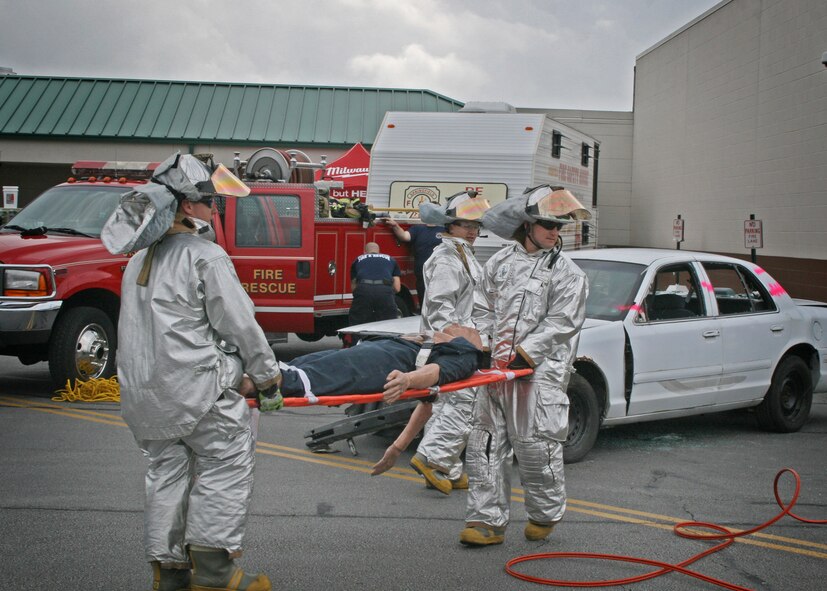 Ohio Air National Guard firefighters from the 180th Fighter Wing, participate in an auto extrication challenge in the Andersen’s parking lot, Maumee, Ohio, September 22, 2012.  180FW firefighters and firefighters from the local area competed and showcased their skills with various tools and scenerios.  (U.S. Air Force courtesy photo/Released)