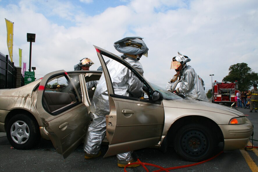 Ohio Air National Guard firefighters from the 180th Fighter Wing, participate in an auto extrication challenge in the Andersen’s parking lot, Maumee, Ohio, September 22, 2012.  180FW firefighters and firefighters from the local area competed and showcased their skills with various tools and scenerios.  (U.S. Air Force courtesy photo/Released)