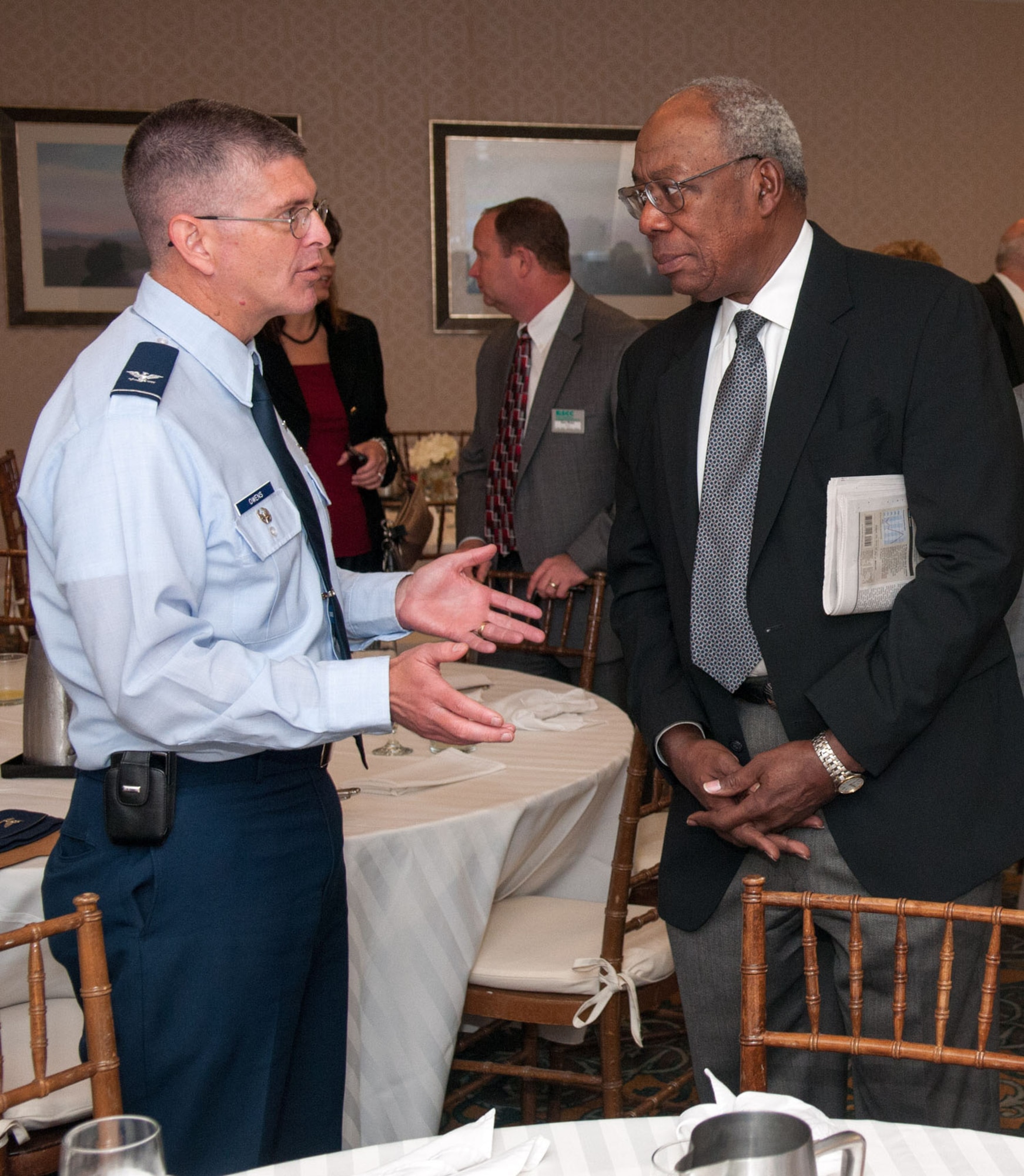 BEDFORD, Mass. - Col. Scott Owens, Theater Battle Control Division senior materiel leader, Air Force Life Cycle Management Center at Hanscom AFB, Mass., speaks to Chuck Cherry, defense industry consultant, during the North Suburban Chamber of Commerce Military Affairs Council meeting Oct. 1 at the Doubletree Bedford Glen Hotel. Owens presented a briefing at the meeting on the importance of open systems and architecture. (U.S. Air Force photo by Rick Berry)