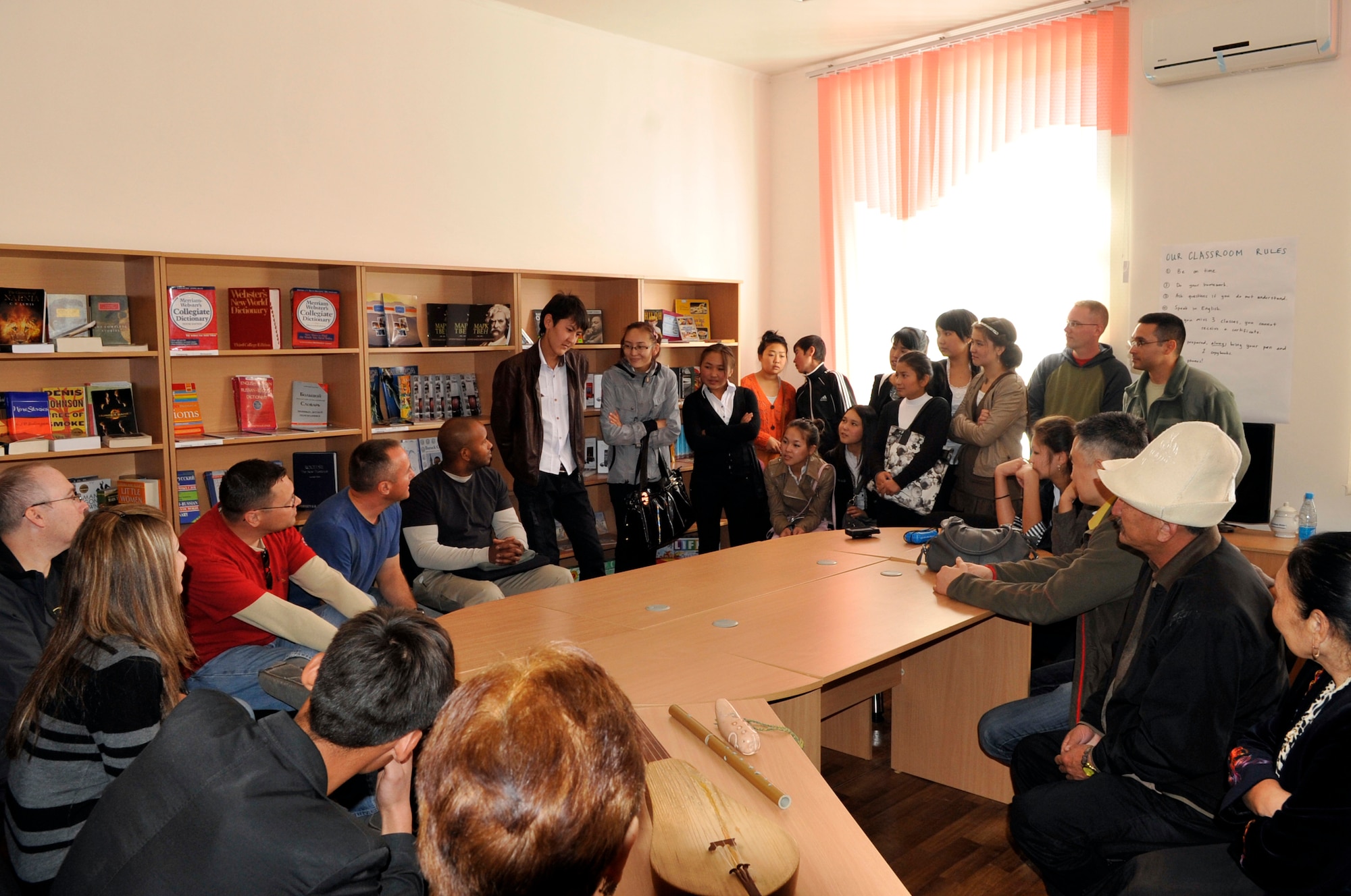 Students from the American Corner take turns asking questions during a visit from the U.S. Air Forces Central Band, "Top Flight," visit Sept. 27, 2012, Naryn Province, Kyrgyzstan. The students and faculty from Naryn were treated to a concert by the band following an English language and music exchange.  The American Corner program provides opportunities for those individuals wanting to improve their English language skills while learning about the U.S. (U.S. Air Force photo/Master Sgt. Jason Vaught)