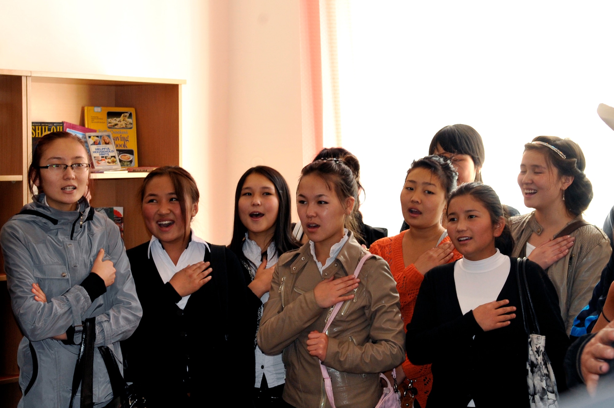 Students from the American Corner sing the Kyrgyz National Anthem during a visit from the U.S. Air Forces Central Band, "Top Flight" visit Sept. 27, 2012, Naryn Province, Kyrgyzstan. The students and faculty from Naryn were treated to a concert by the band following an English language and music exchange.  The American Corner program provides opportunities for those individuals wanting to improve their English language skills while learning about the U.S. (U.S. Air Force photo/Master Sgt. Jason Vaught)