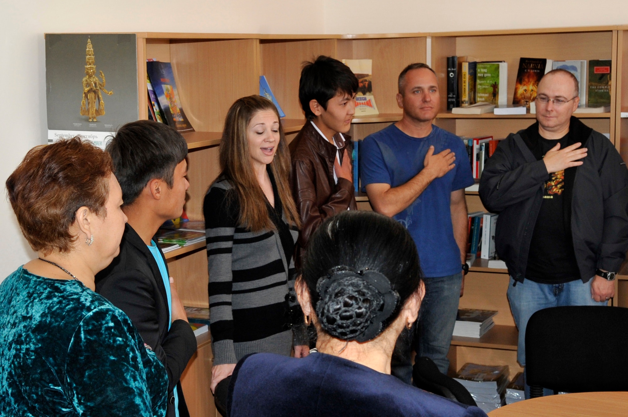 Center, Tech. Sgt. Christin Foley sings the U.S. National Anthem A capella for Kyrgyz Republic students and staff during a visit Sept. 27, 2012 to the American Corner in Naryn, Kyrgyzstan. Foley is the the U.S. Air Forces Central Band, "Top Flight" lead vocalist who is stationed at Joint Base San Antonio, Texas and is a native of Cleveland. She is on her second tour to Kyrgyzstan and looks forward to more opportunities to share music experiences locally. (U.S. Air Force photo/Master Sgt. Jason Vaught)