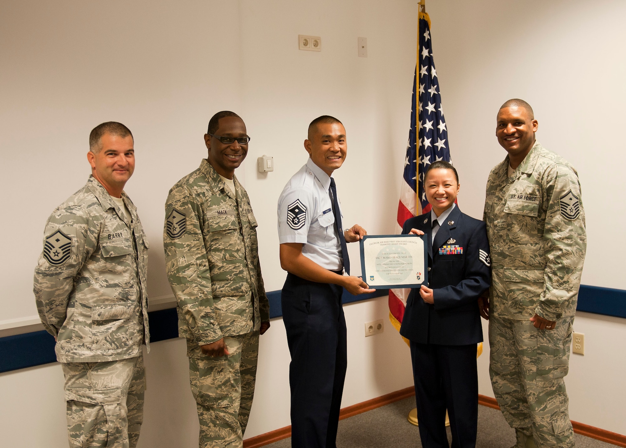 Staff Sgt. Mary Martin, 39th Communications Squadron, is presented the September 2012 Diamond Sharp Award by members of the Incirlik First Sergeant Council Oct. 4, 2012, at Incirlik Air Base, Turkey. Martin earned the monthly award by distinguishing herself through outstanding professionalism, performance and display of the Air Force core values. (U.S. Air Force photo by Senior Airman Clayton Lenhardt/Released)