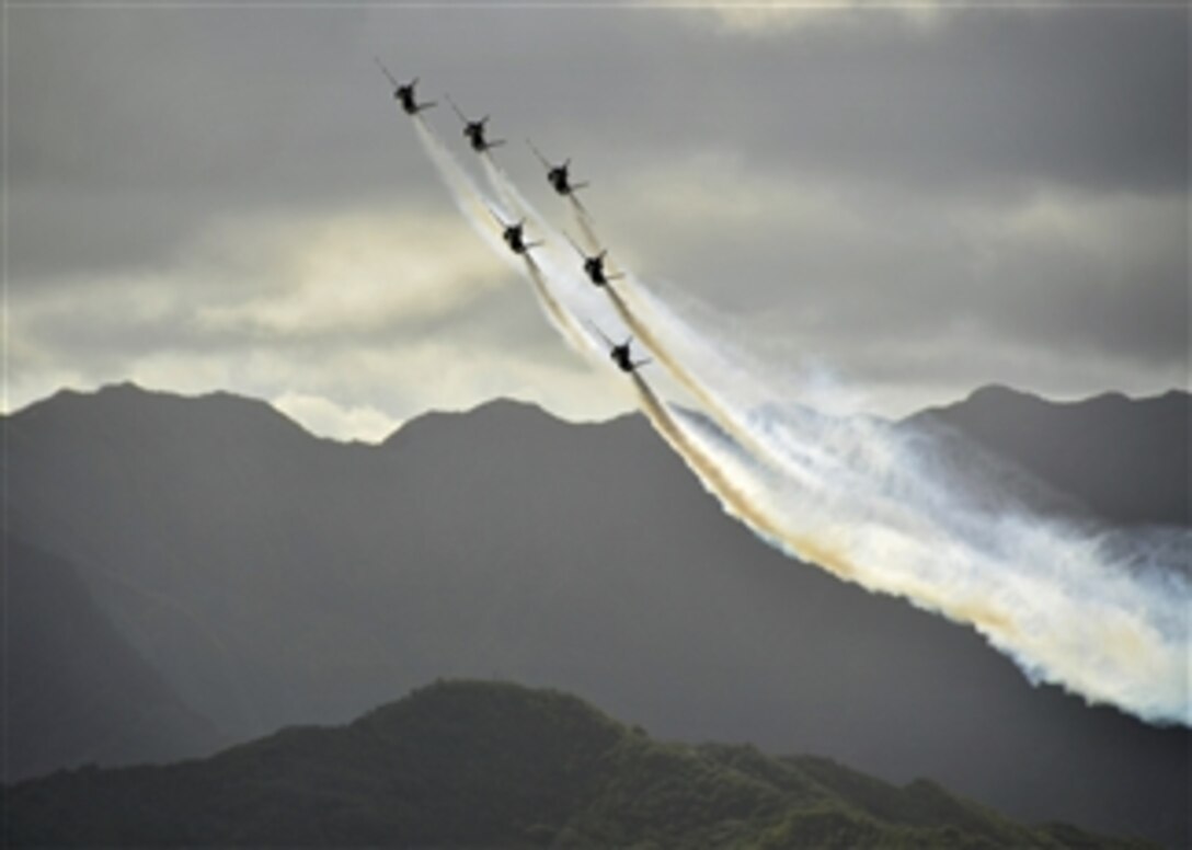 The U.S. Navy Flight Demonstration Squadron Blue Angels prepare to make an overhead pass as they perform in F/A-18 Hornet aircraft during the 2012 Kaneohe Bay air show at Marine Corps Base Hawaii, on Sept. 30, 2012.  