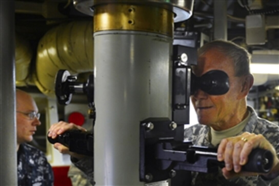 Army Gen. Martin E. Dempsey, chairman of the Joint Chiefs of Staff, looks through the periscope of the USS Maine submarine at Naval Base Kitsap-Bangor in Silverdale, Wash., Oct. 3, 2012.