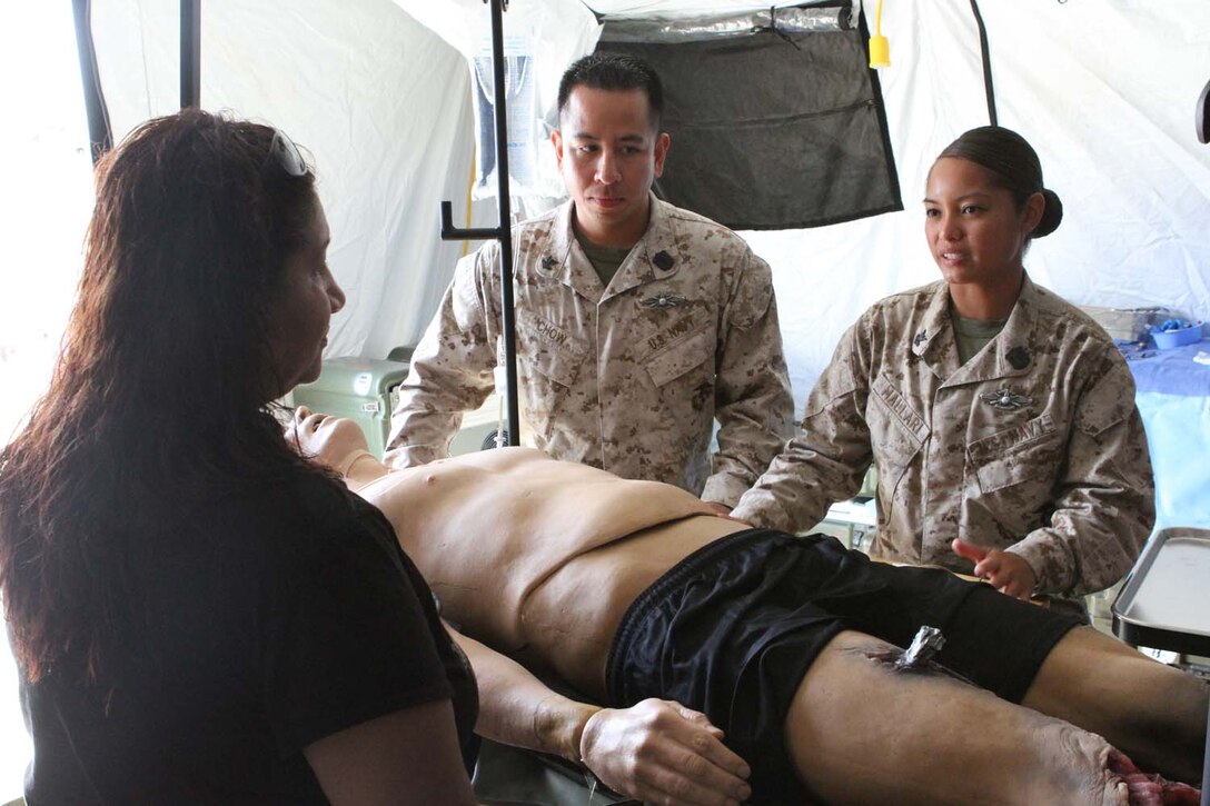 Petty Officer 2nd Class Anthony Chow and Petty Officer 2nd Class Tara Mallari, corpsmen serving with 1st Medical Battalion, instruct how to properly treat casualties of a natural disaster during San Francisco Fleet Week Oct. 3, 2012. Fleet Week is dedicated to showing civilians the United States military's capability of humanitarian assistance and disaster response preparedness on the home front.